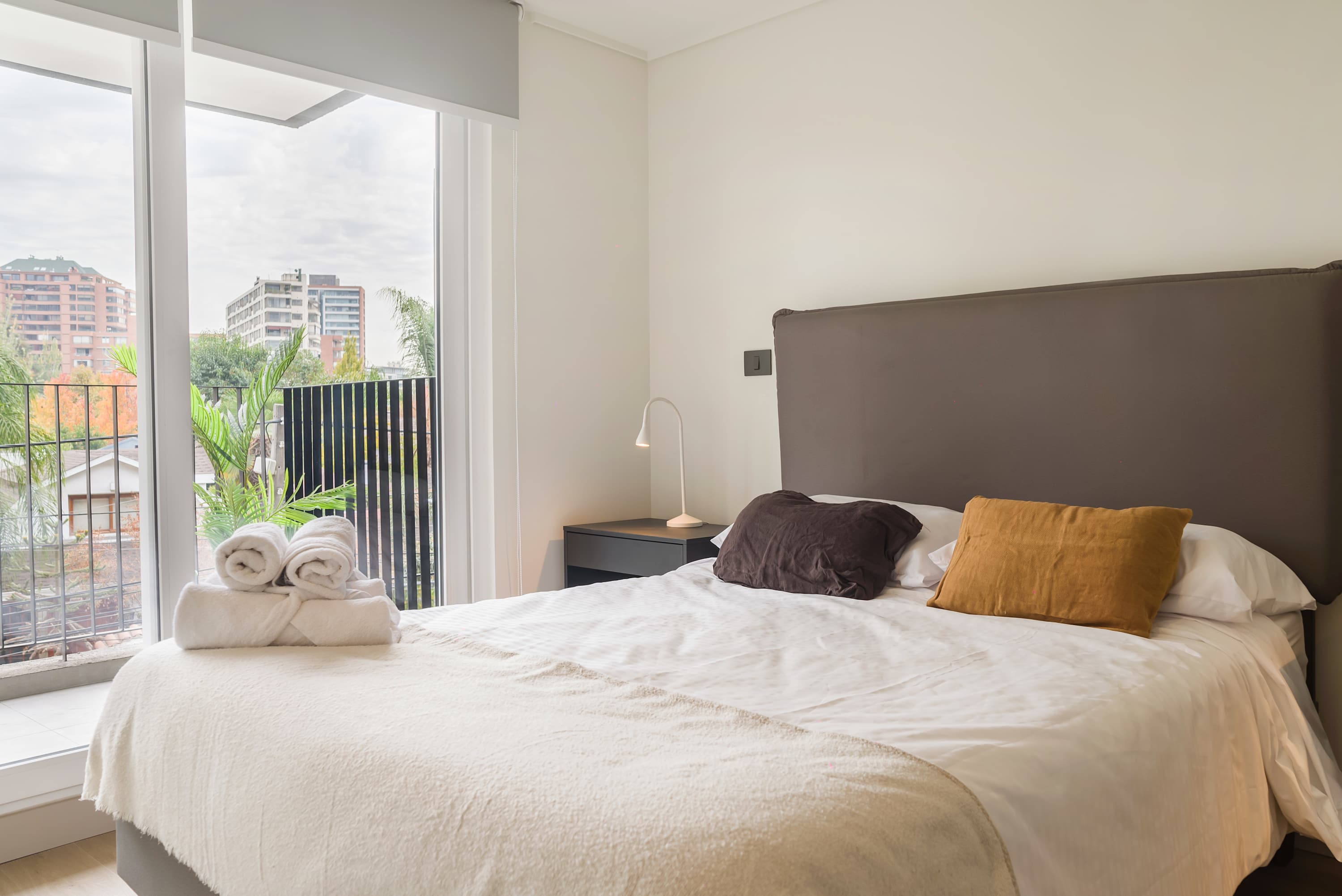 Relax in this cozy bedroom with a large window offering stunning city views and ample natural light.
