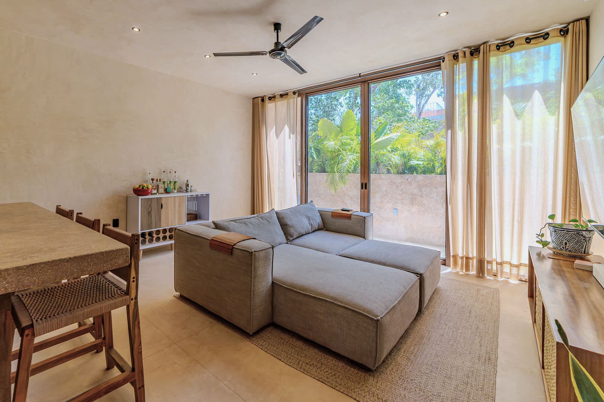 Spacious and bright living room with Smart TV, comfortable seating.