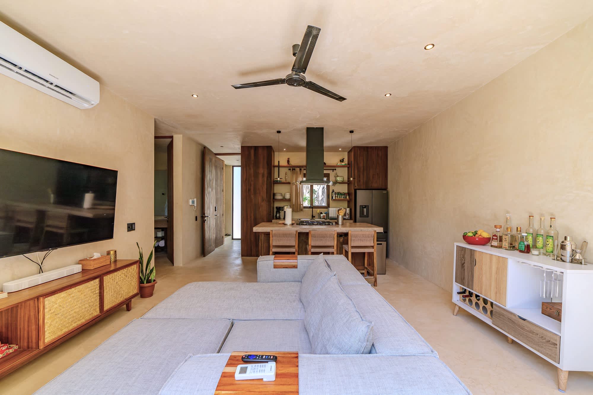 Spacious and bright living room with Smart TV, comfortable seating.