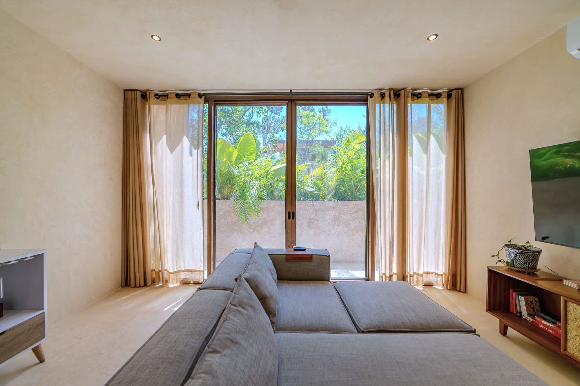 Spacious and bright living room with Smart TV, comfortable seating.