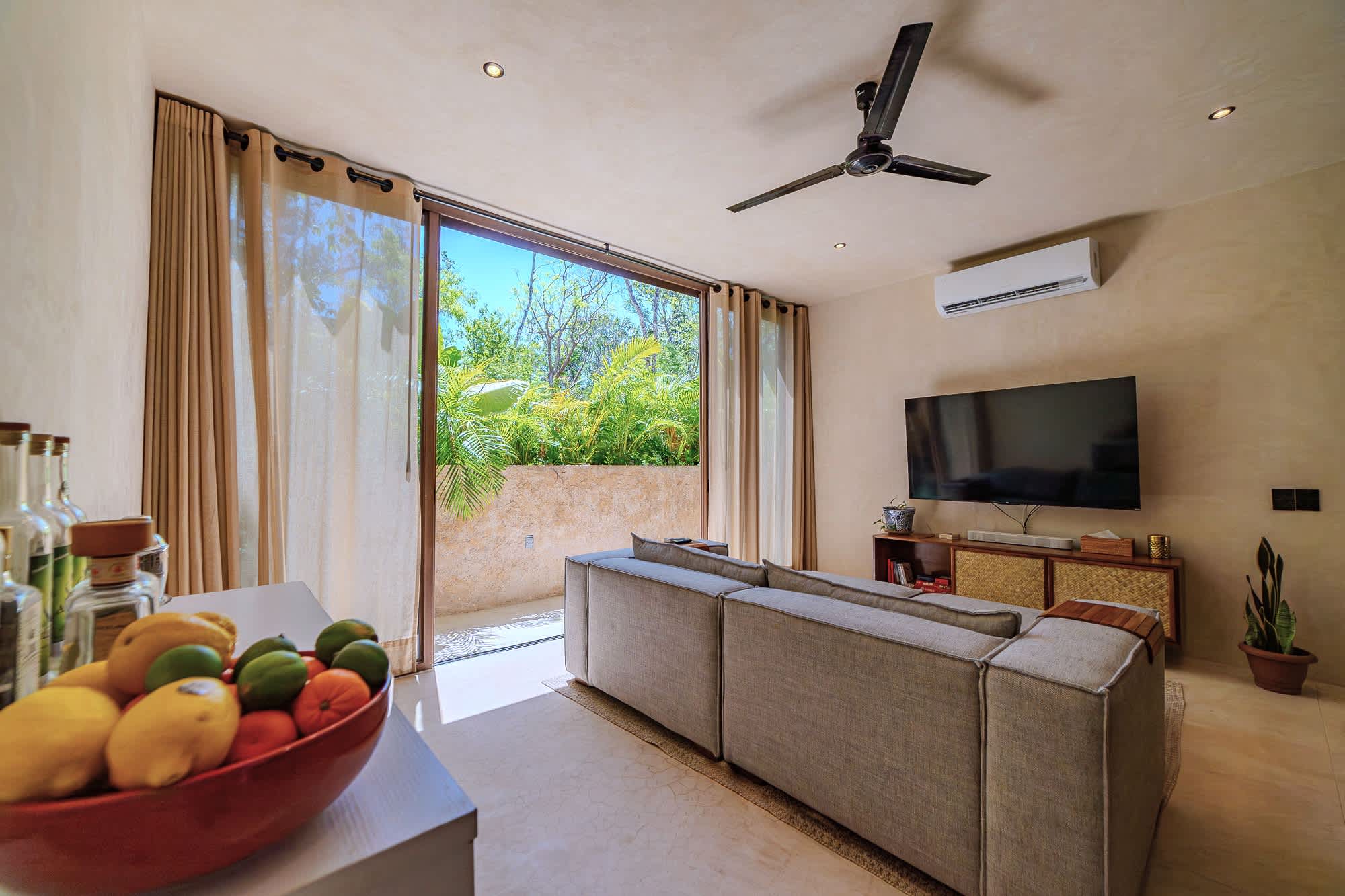 Spacious and bright living room with Smart TV, comfortable seating.