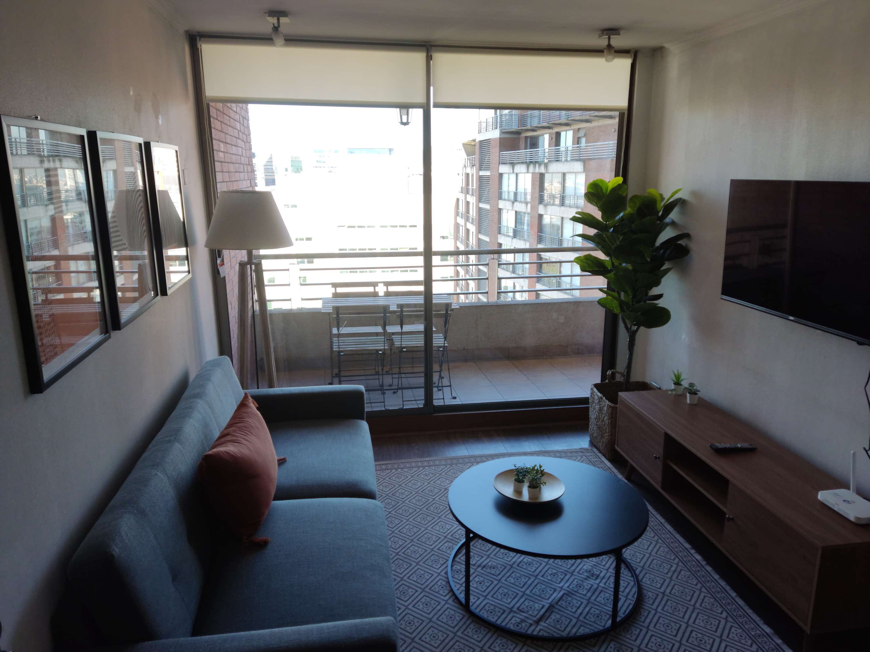 Relax in this cozy living room with balcony access and city views, perfect for unwinding after a day of exploring.