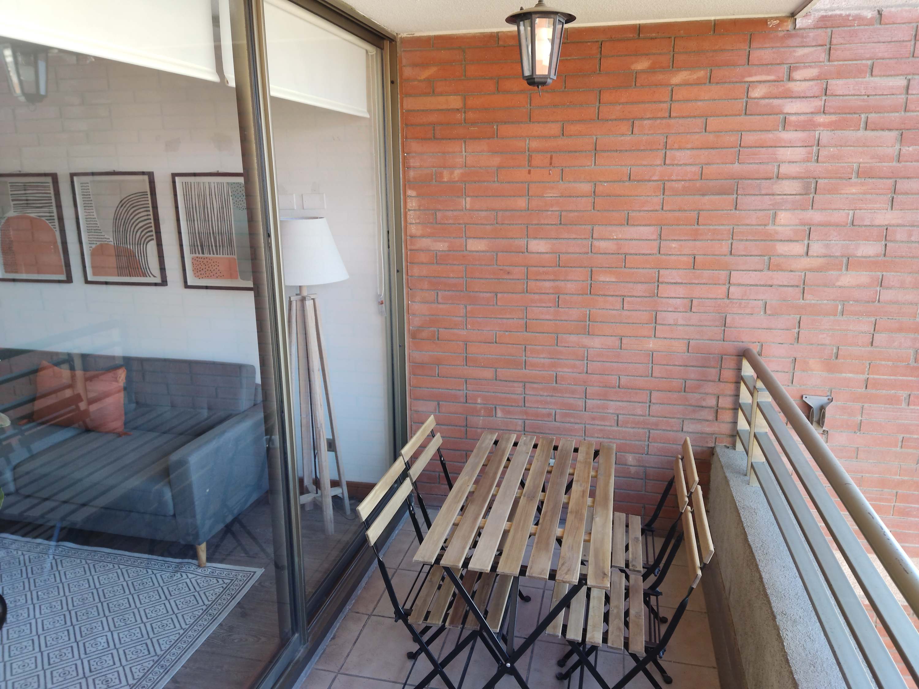 Cozy balcony with seating for four, perfect for enjoying morning coffee or evening relaxation.