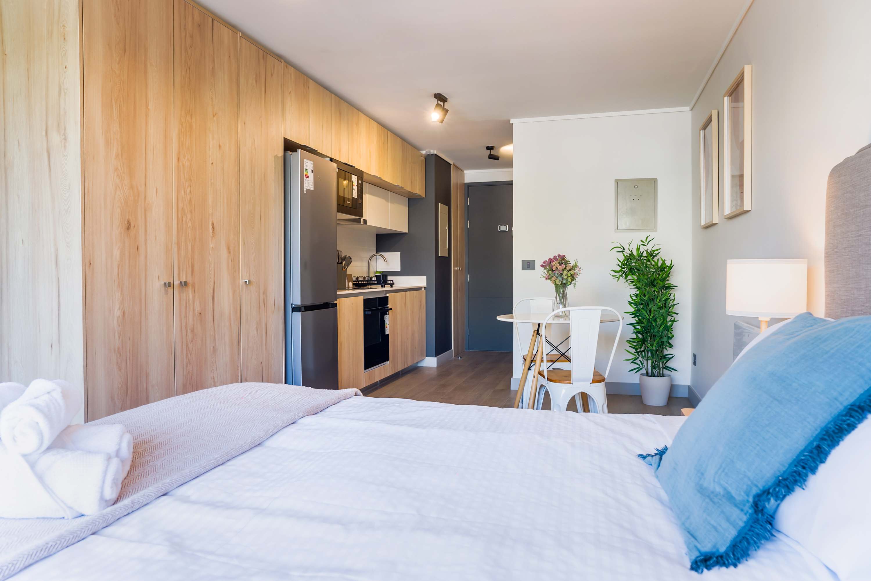 Experience cozy living in this stylish studio with modern kitchen, inviting dining area, and serene decor perfect for a relaxing stay.