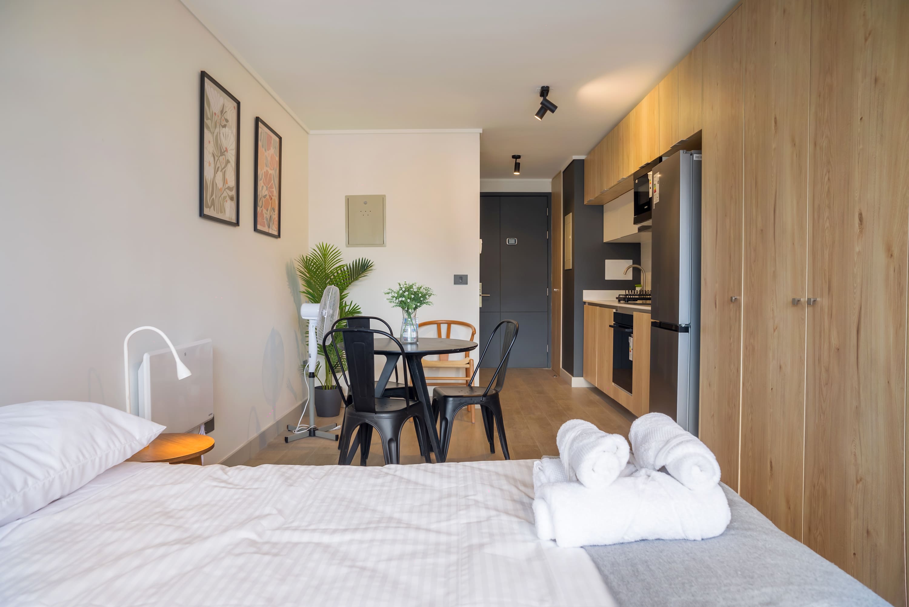 Chic studio apartment with modern amenities and a cozy dining area, perfect for a comfortable stay in the heart of the city.