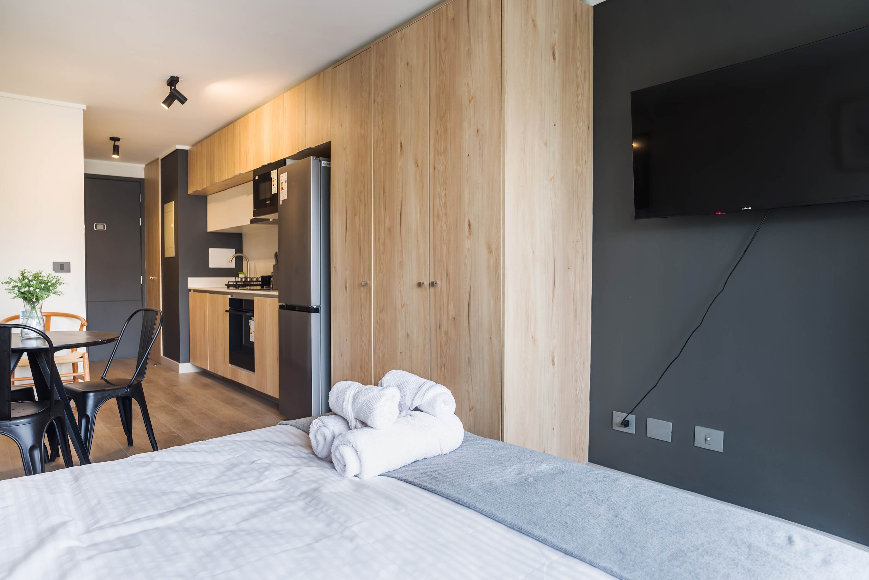 Modern studio with sleek kitchenette and cozy dining area, perfect for a comfortable stay in the heart of the city.