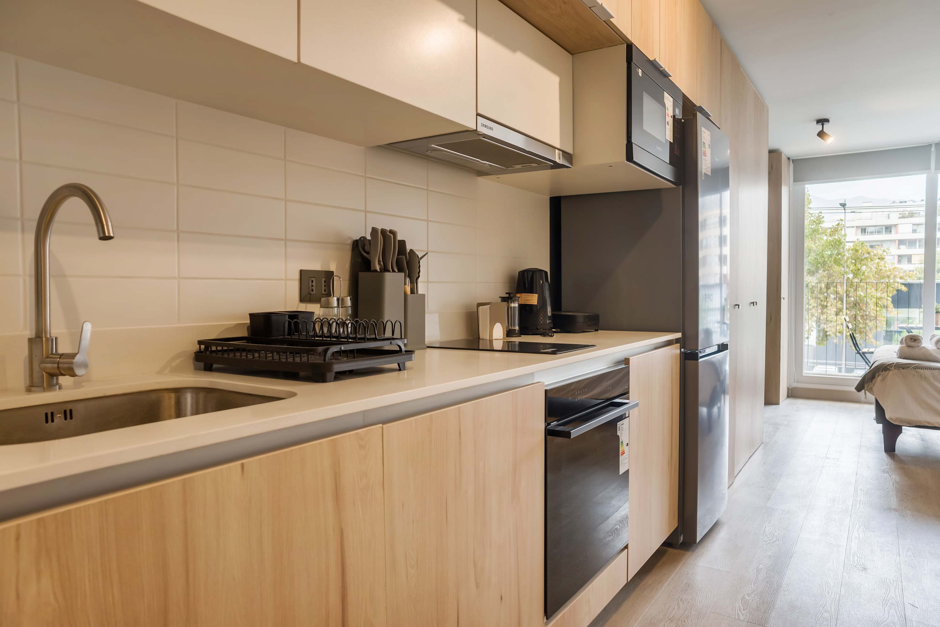 Sleek and modern kitchen with all essentials, perfect for a cozy meal in your private studio apartment.