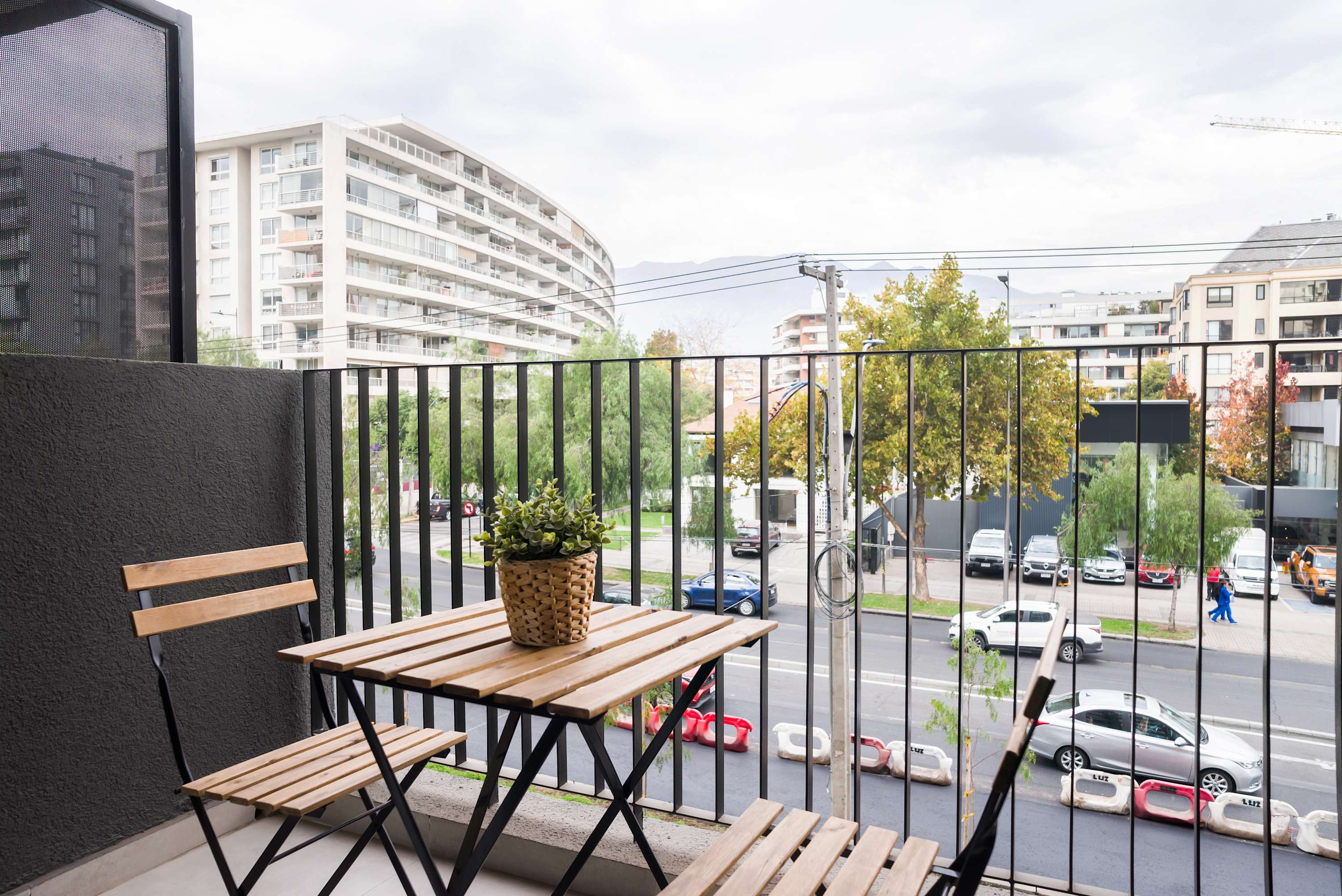 Enjoy a relaxing morning coffee on your private balcony with city views.