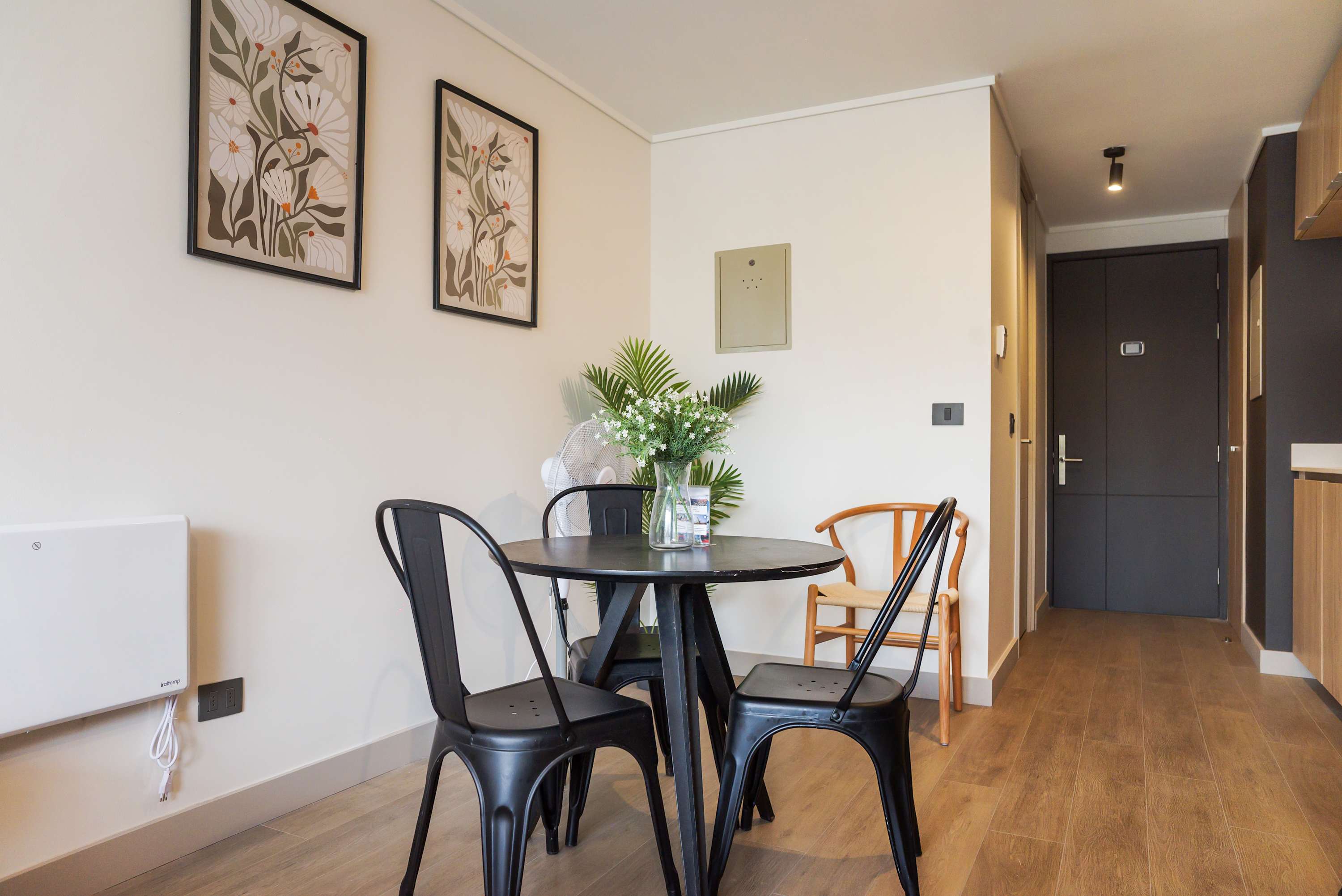 Cozy dining nook with stylish decor and natural light, perfect for intimate meals.