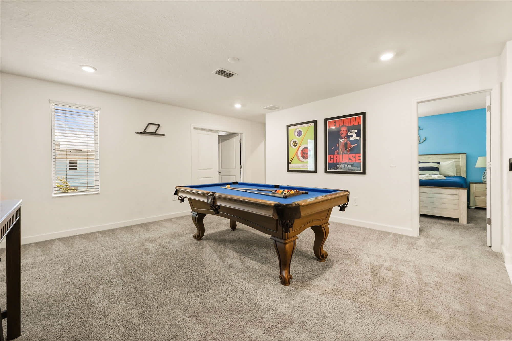 Enjoy a game of pool in this spacious and inviting game room, perfect for entertainment and relaxation.