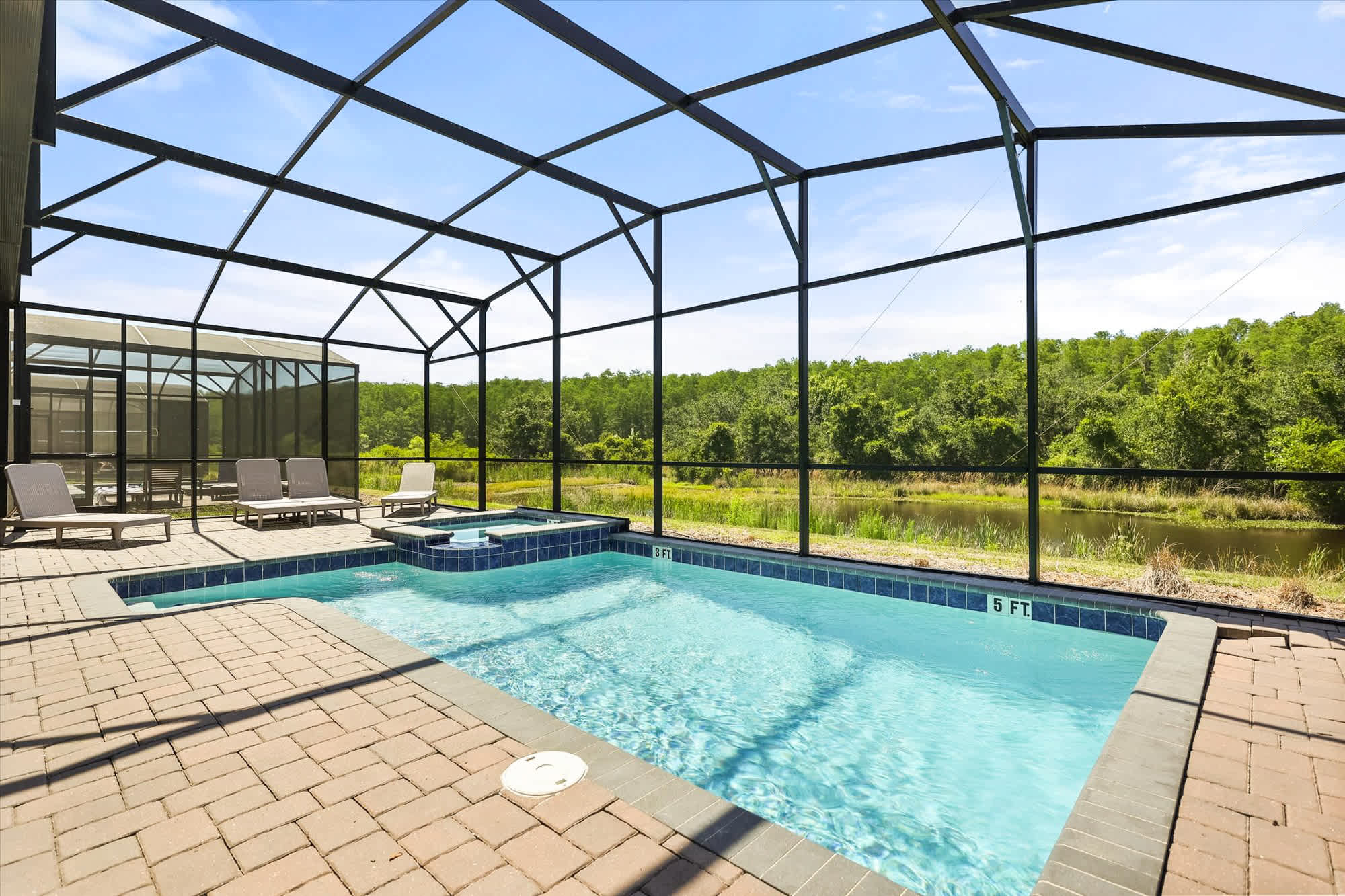 Relax in your private screened-in pool and hot tub with stunning nature views—perfect for unwinding and enjoying the outdoors.