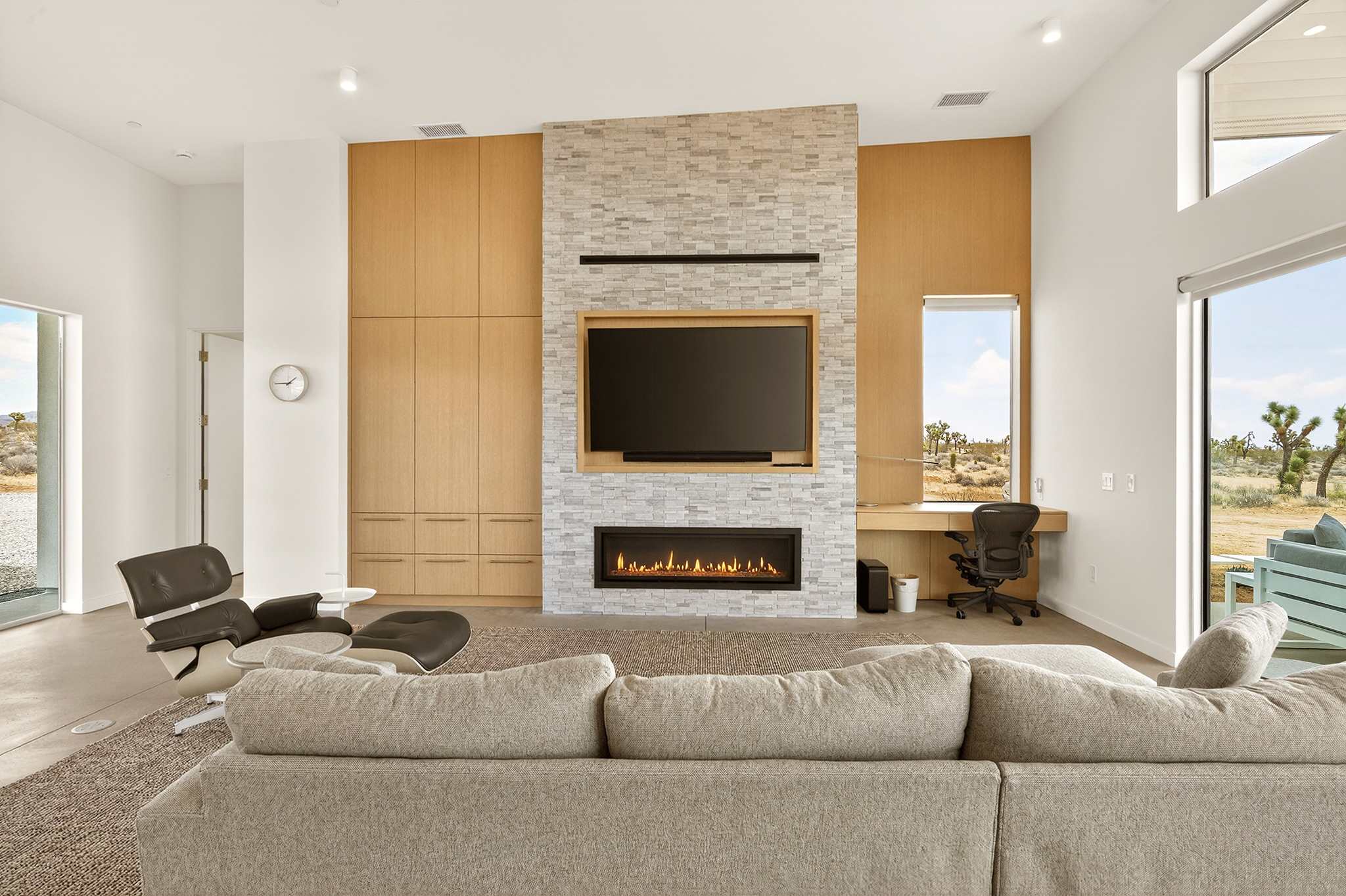 Living Room with indoor fireplace and desk.