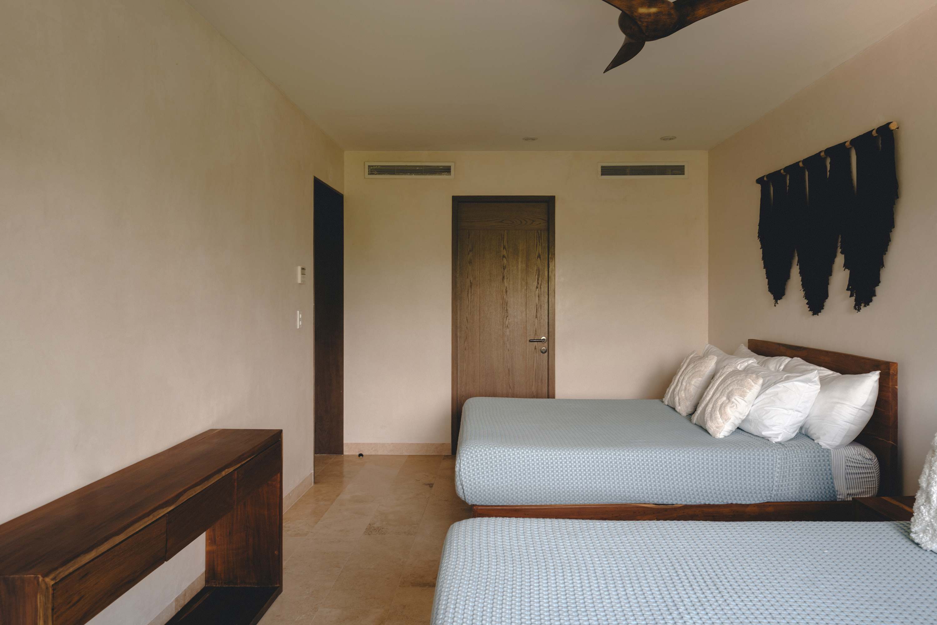 Spacious and minimalist bedroom with two beds