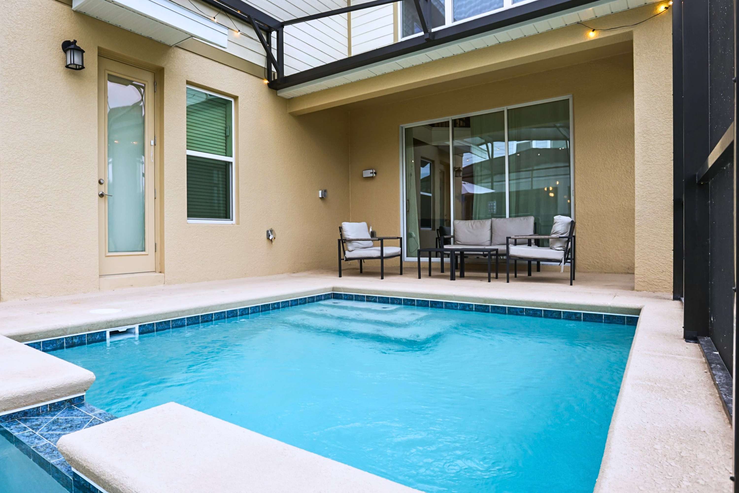 Pool and spa lounge area with comfortable seating, perfect for relaxing afternoons and evening swims