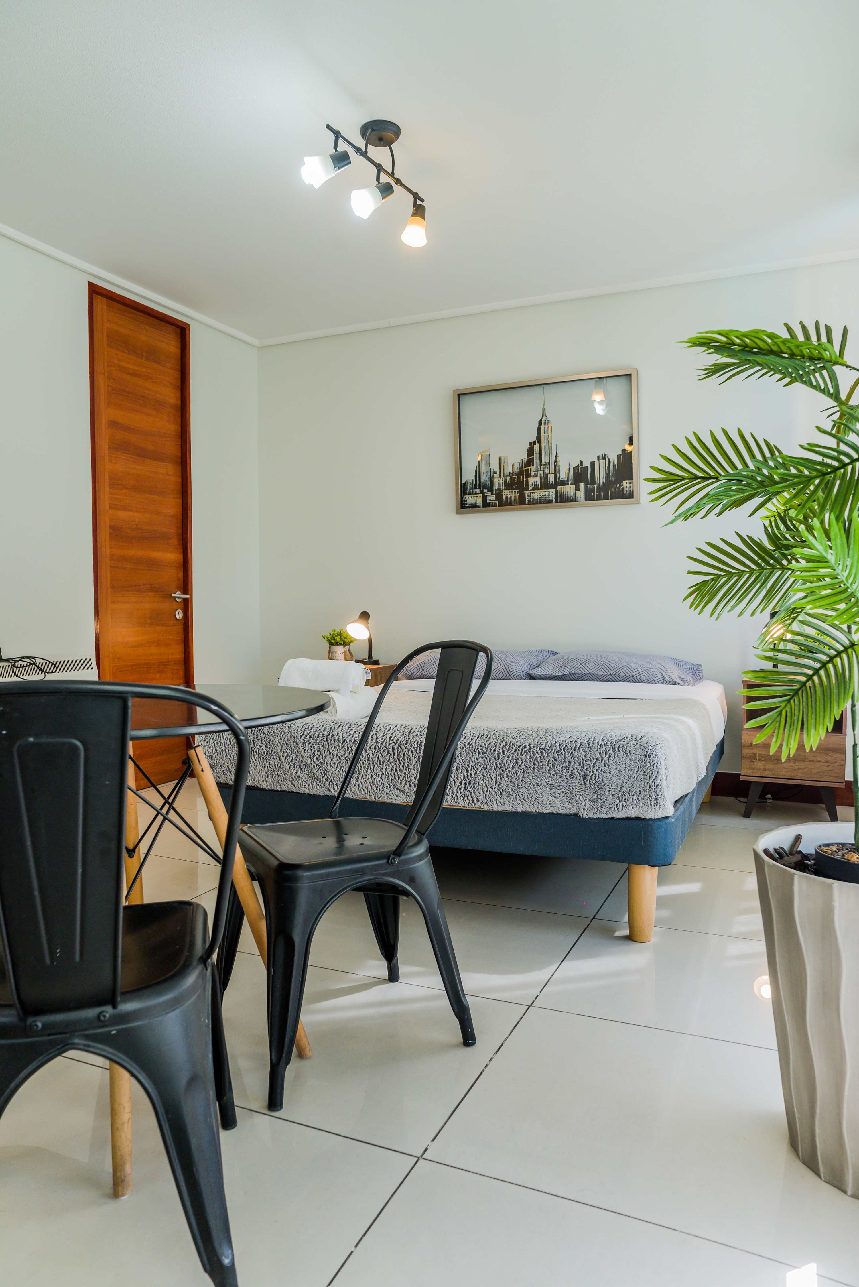 Cozy studio apartment with modern decor and ample natural light, perfect for a relaxing stay in the heart of the city.