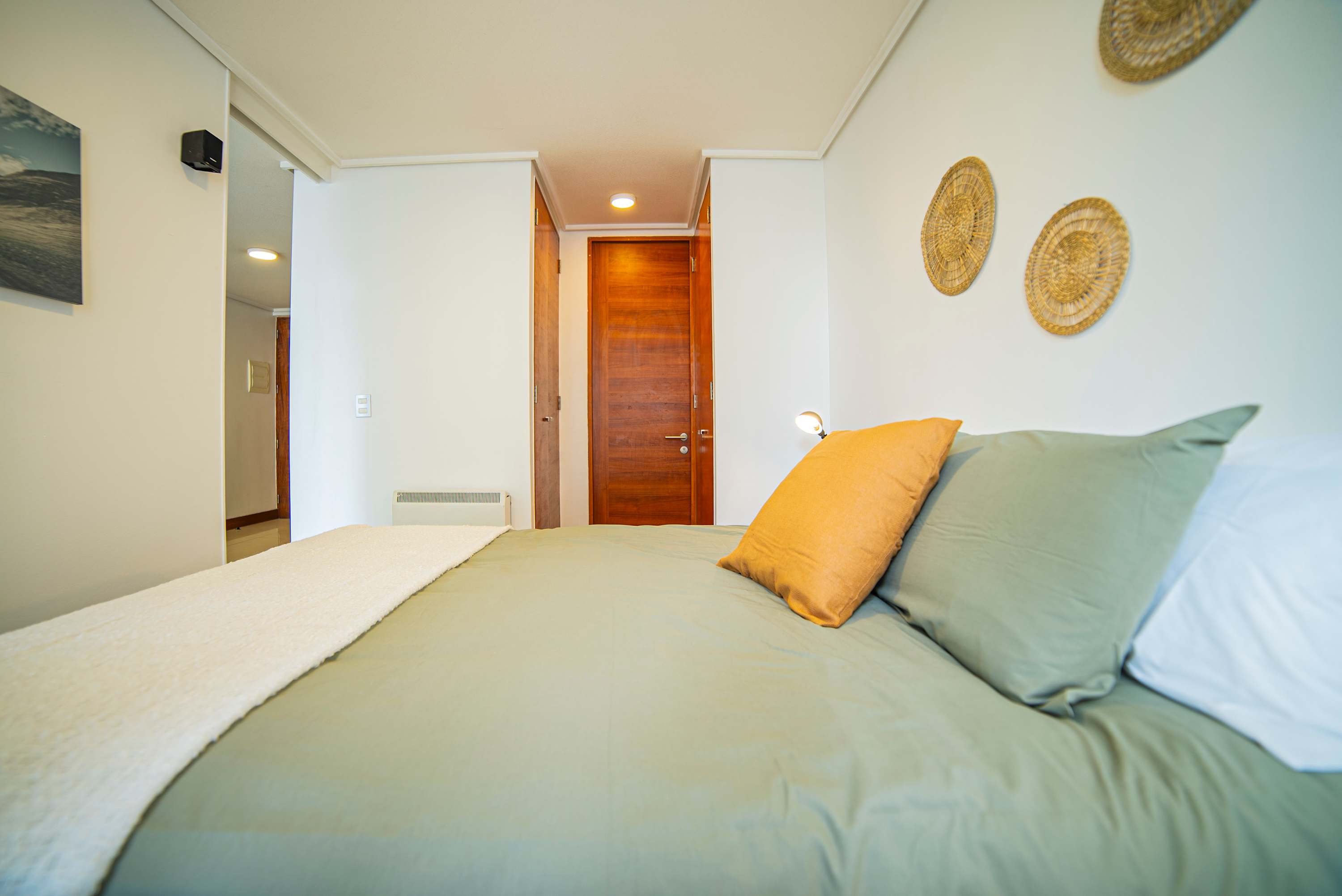 Relax in this cozy bedroom with stylish decor and warm lighting, perfect for a restful stay.