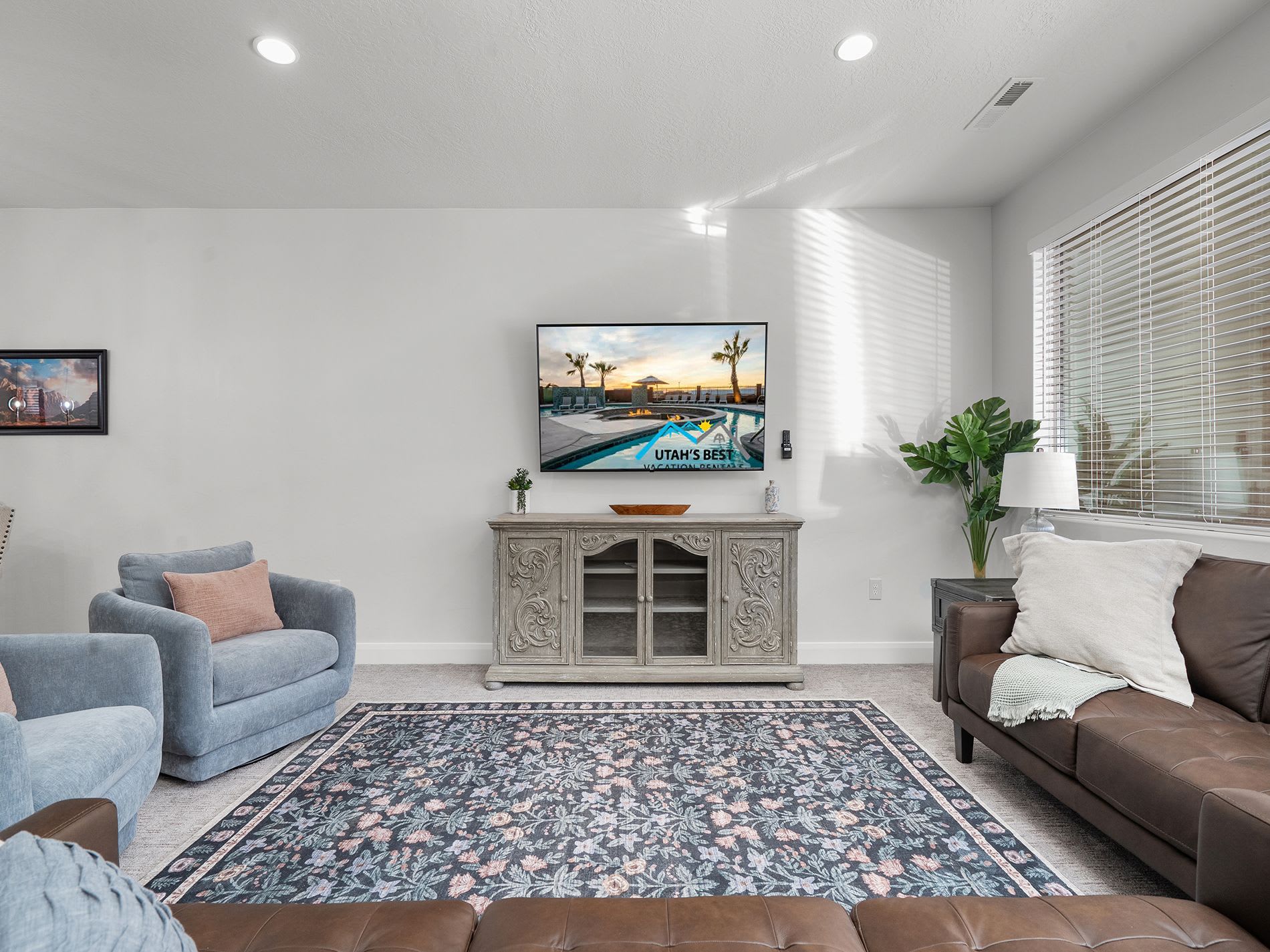 Cozy entertainment space featuring large TV and stylish furnishings