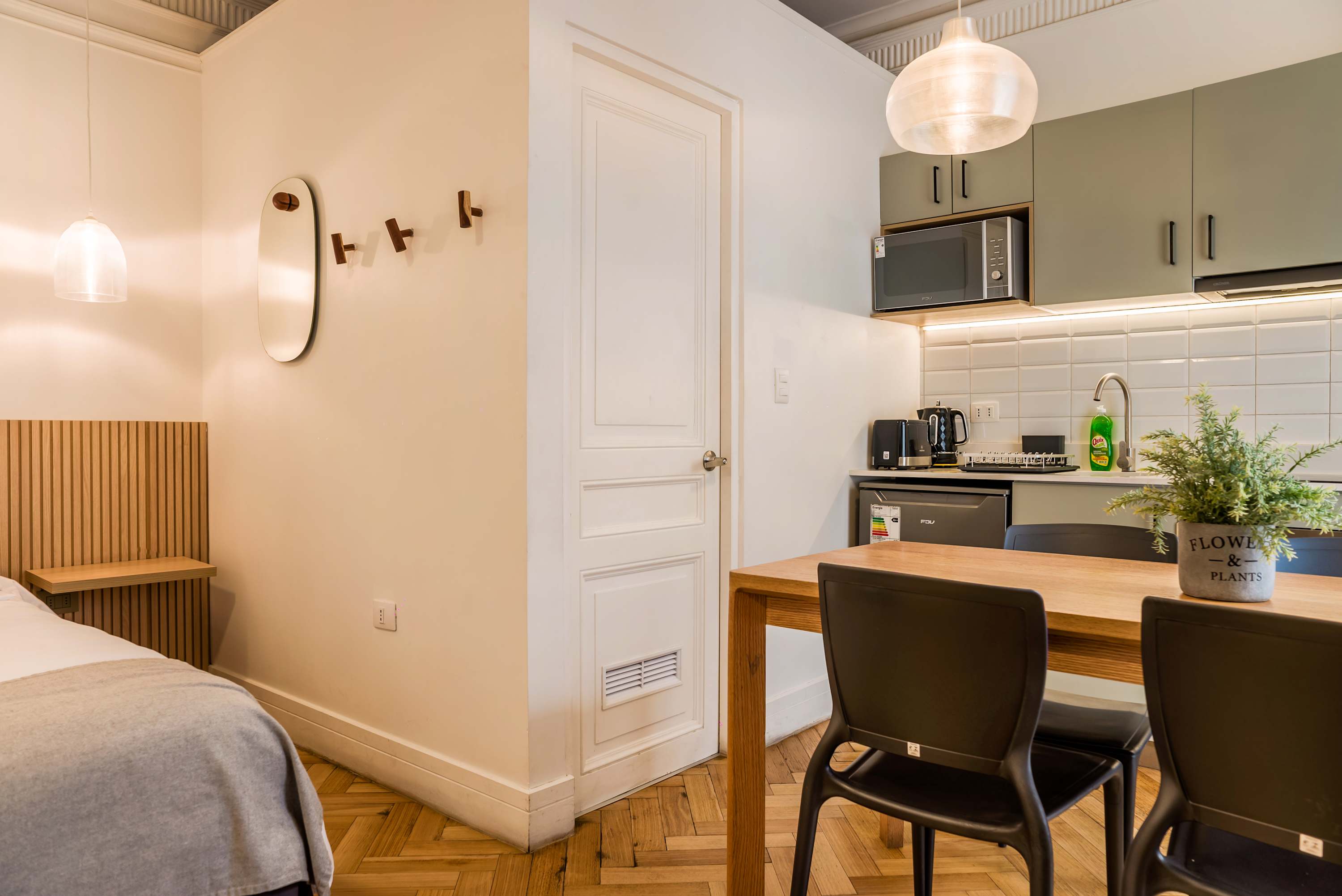 Cozy kitchen area with modern appliances and a stylish dining setup, perfect for enjoying meals in a compact space.