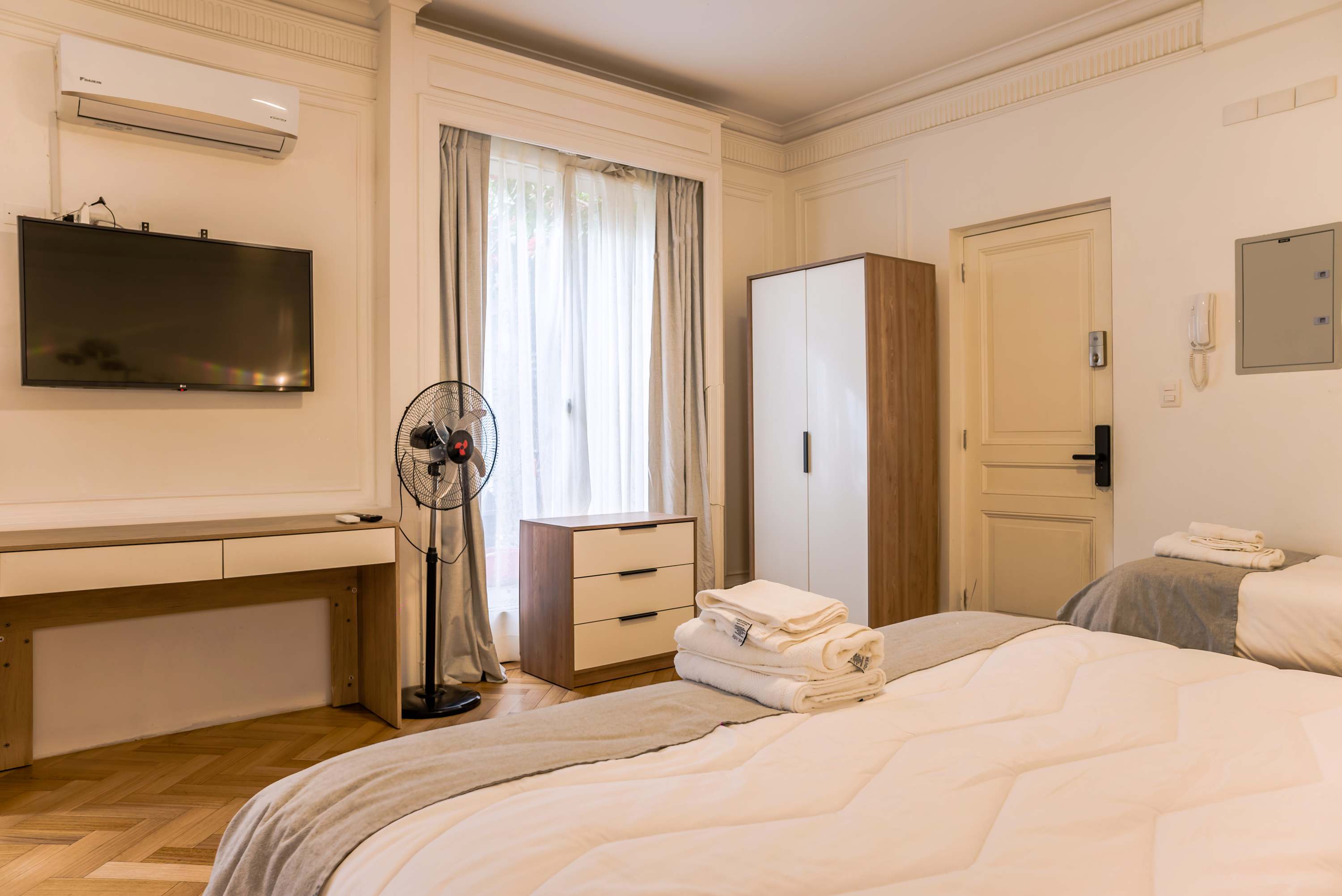 Cozy studio with modern amenities, including a flat-screen TV and ample storage. Perfect for a comfortable stay in the heart of the city.