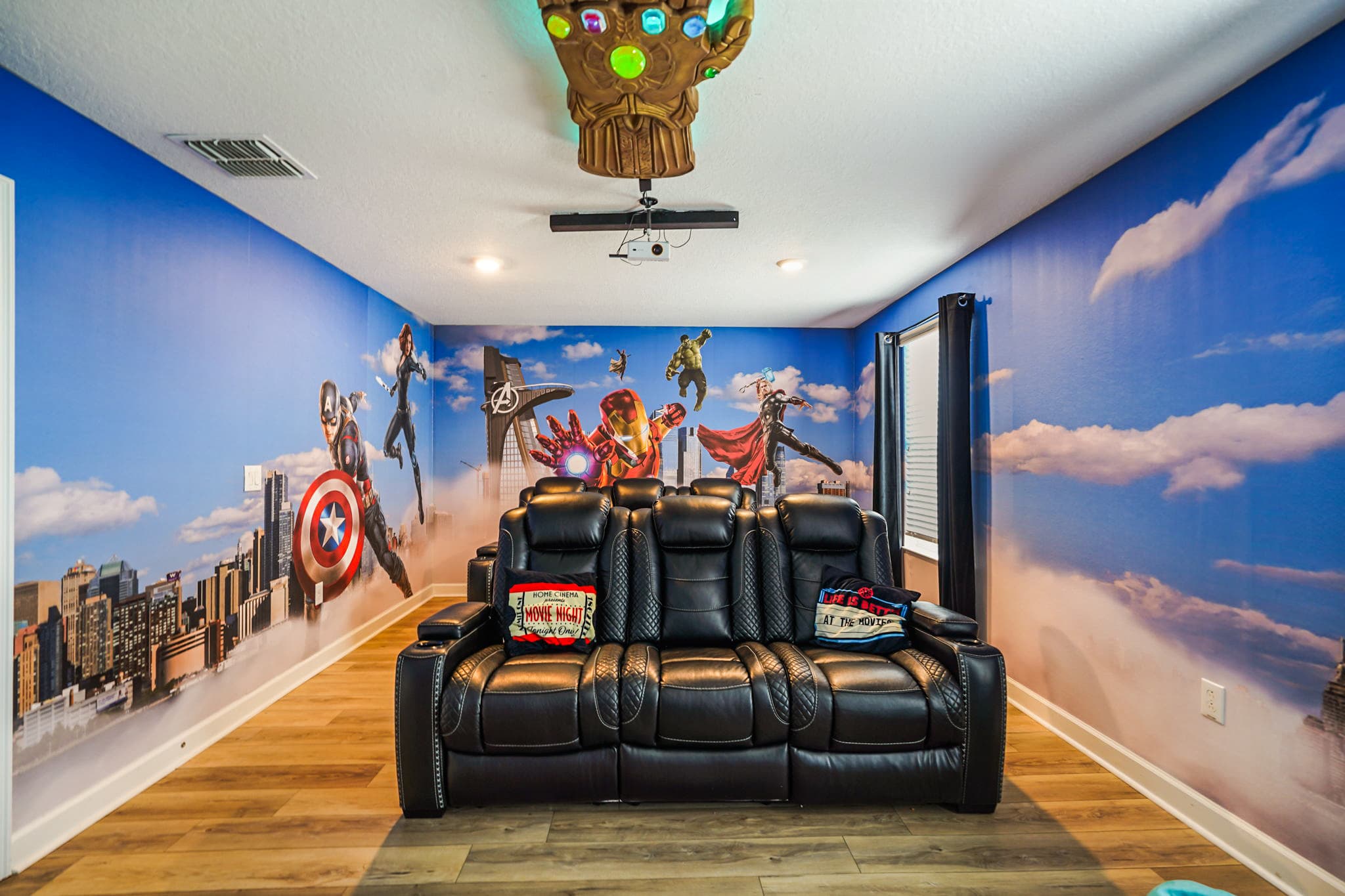 Dive into superhero adventures in this themed home theater with plush recliners and epic murals, perfect for unforgettable movie nights.