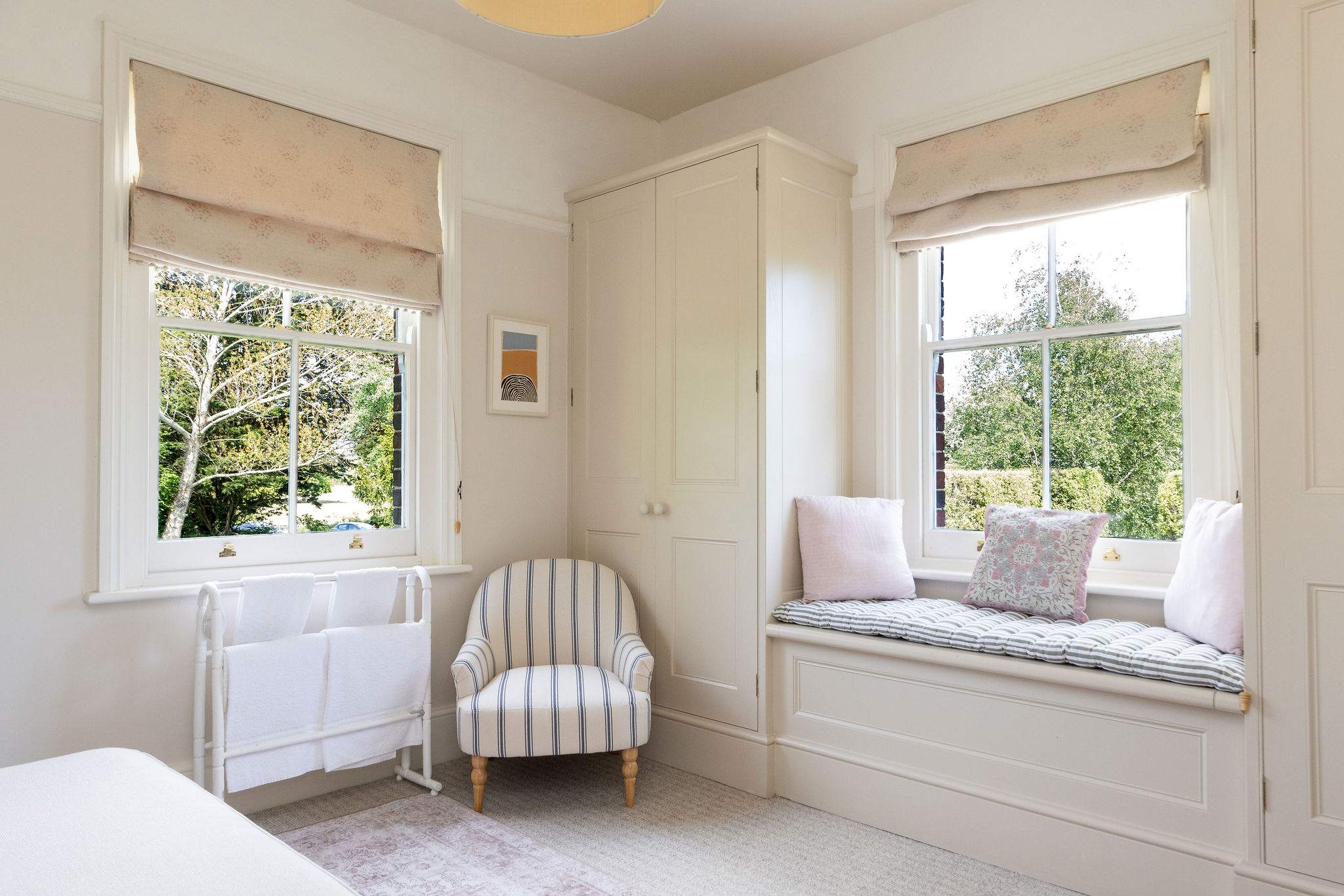 Bright bedroom corner with charming countryside touches.