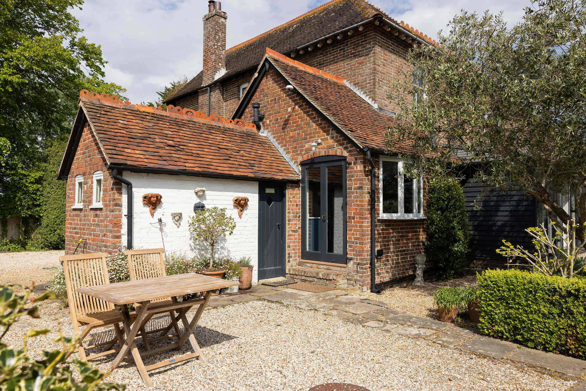 Charming annexe exterior with private outdoor seating area.