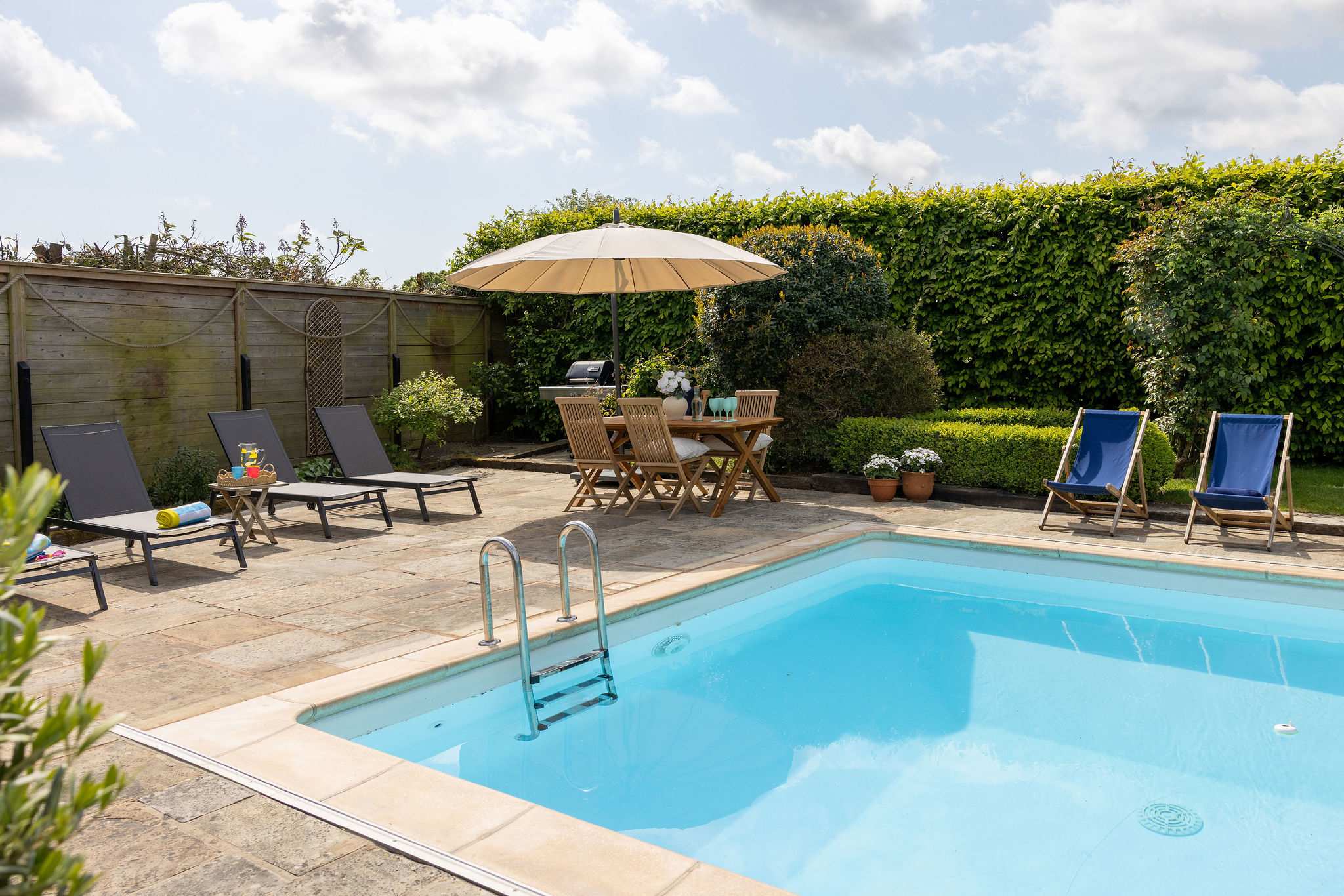 Sunny poolside area designed for laid-back outdoor living.