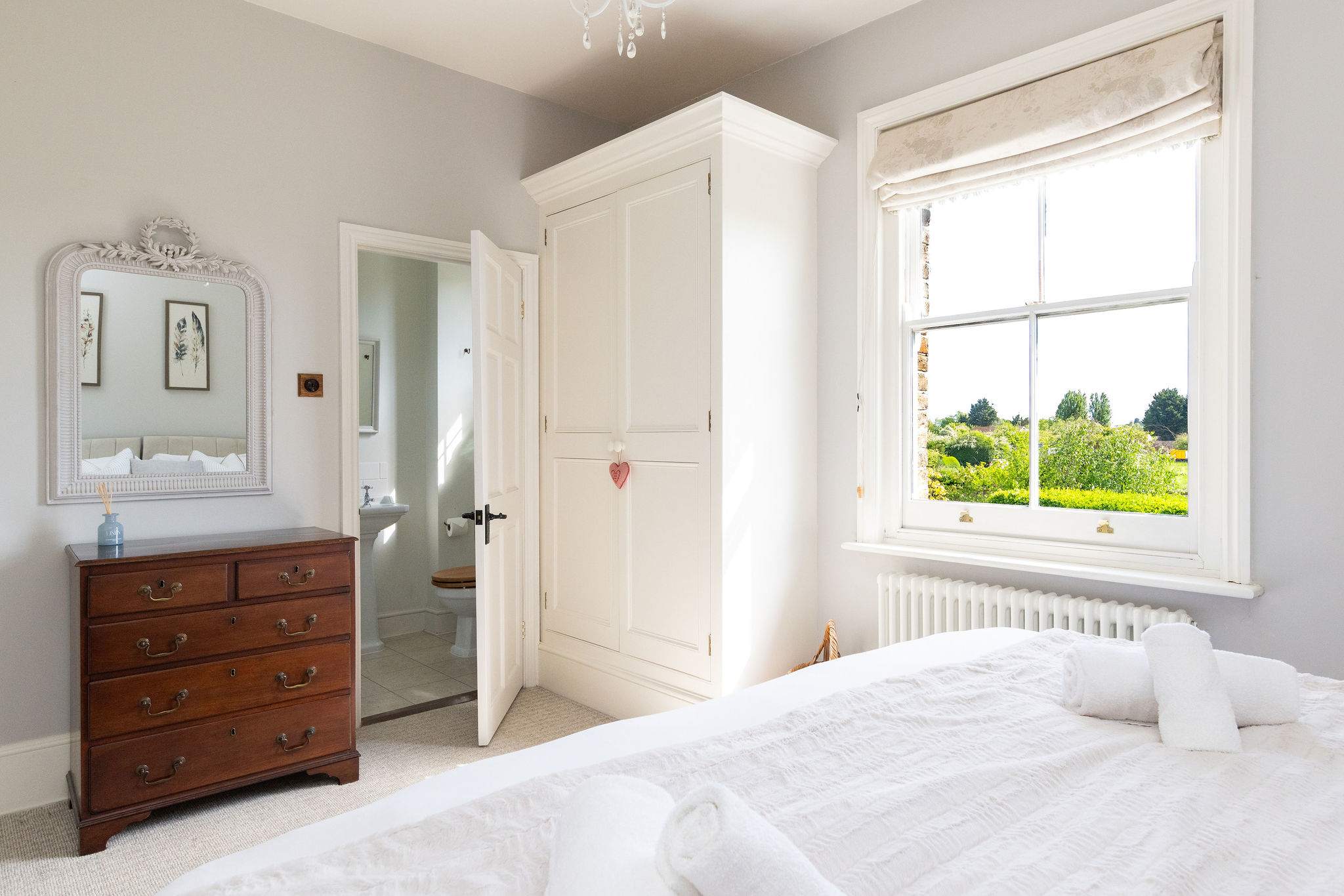 Spacious bedroom with countryside charm and natural light.