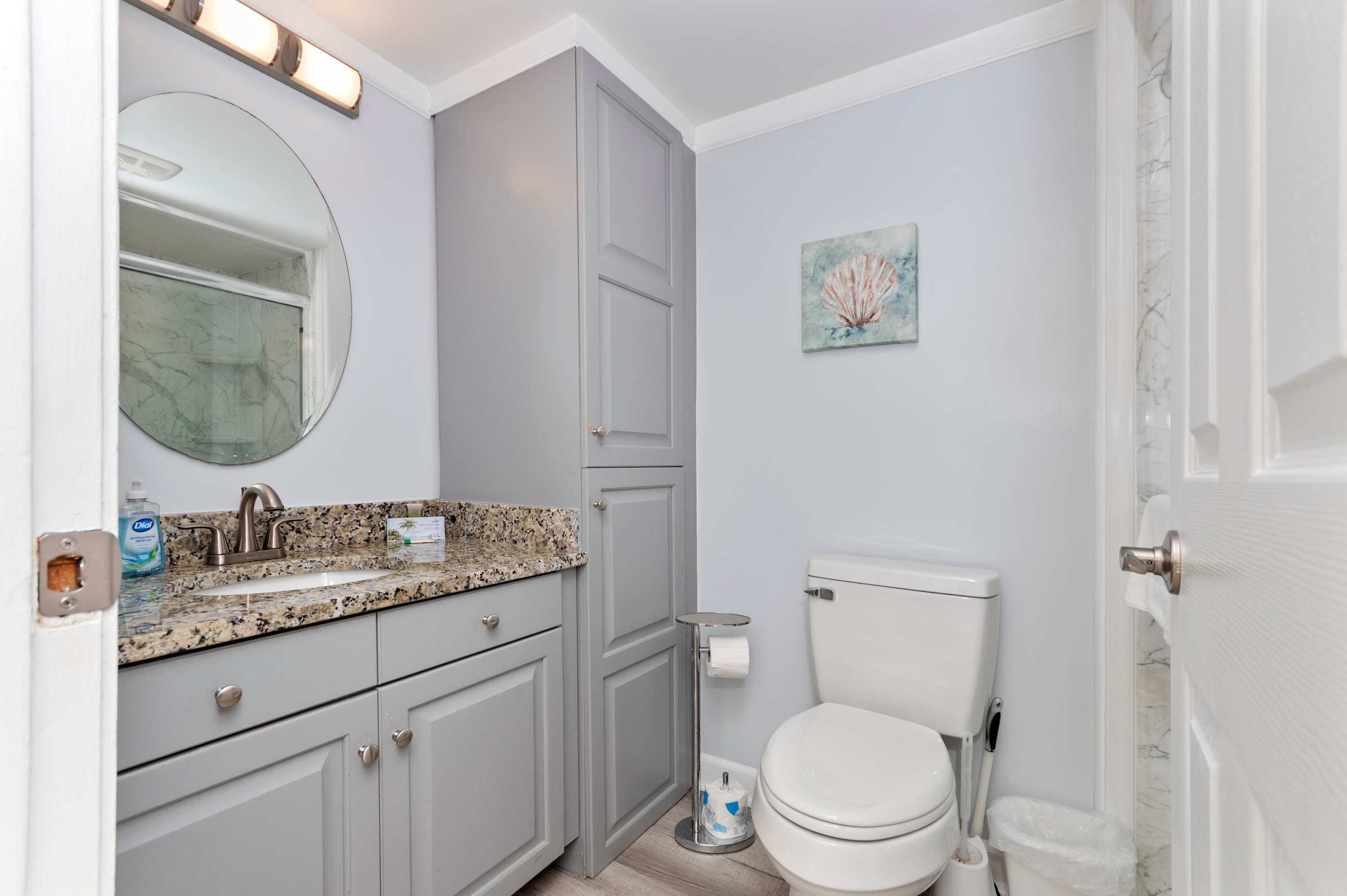 This sparkling clean bathroom combines comfort, convenience, and calming beach-inspired décor.
