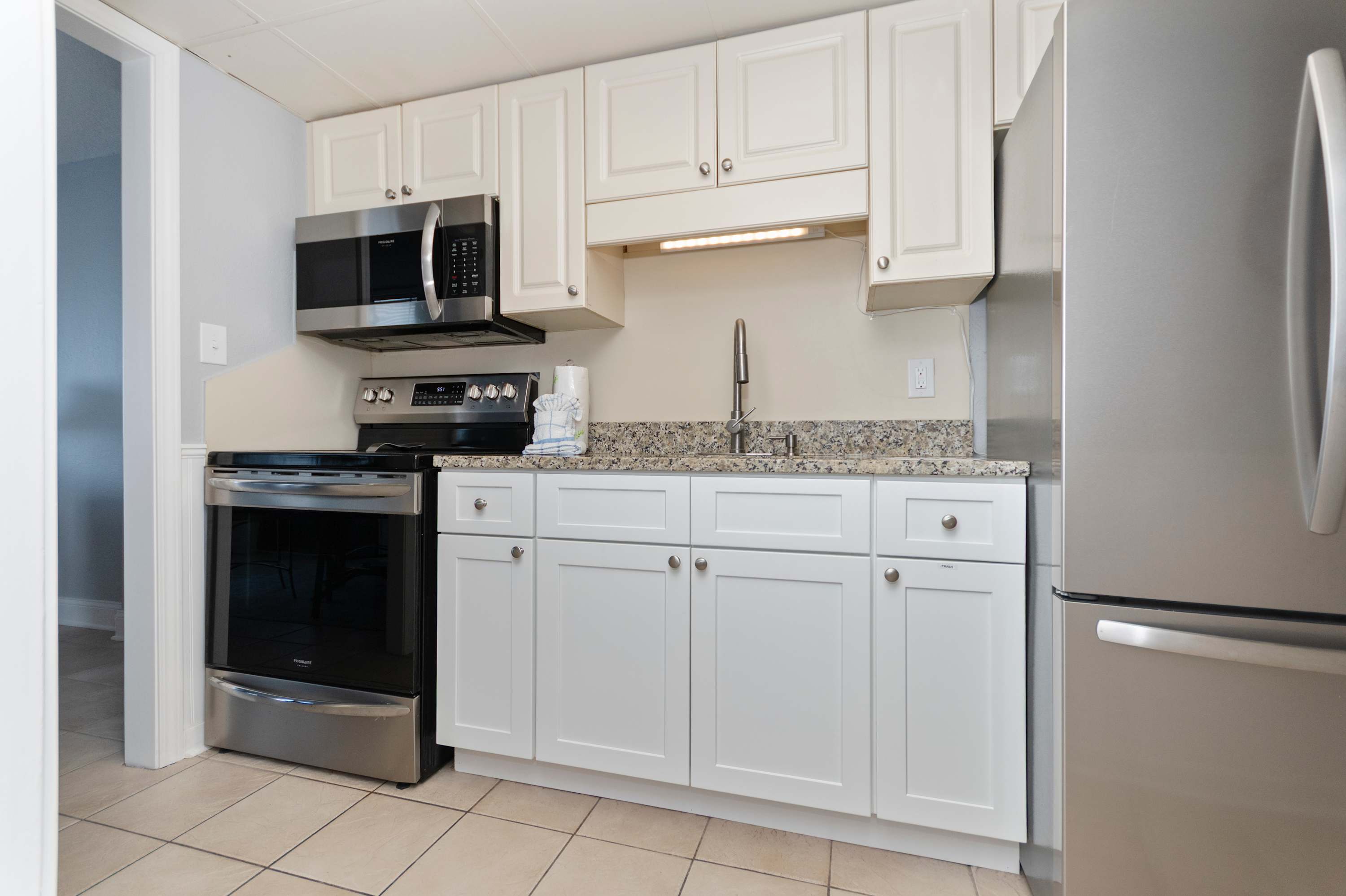 Cook your favorite meals with ease in this bright and fully equipped vacation kitchen.