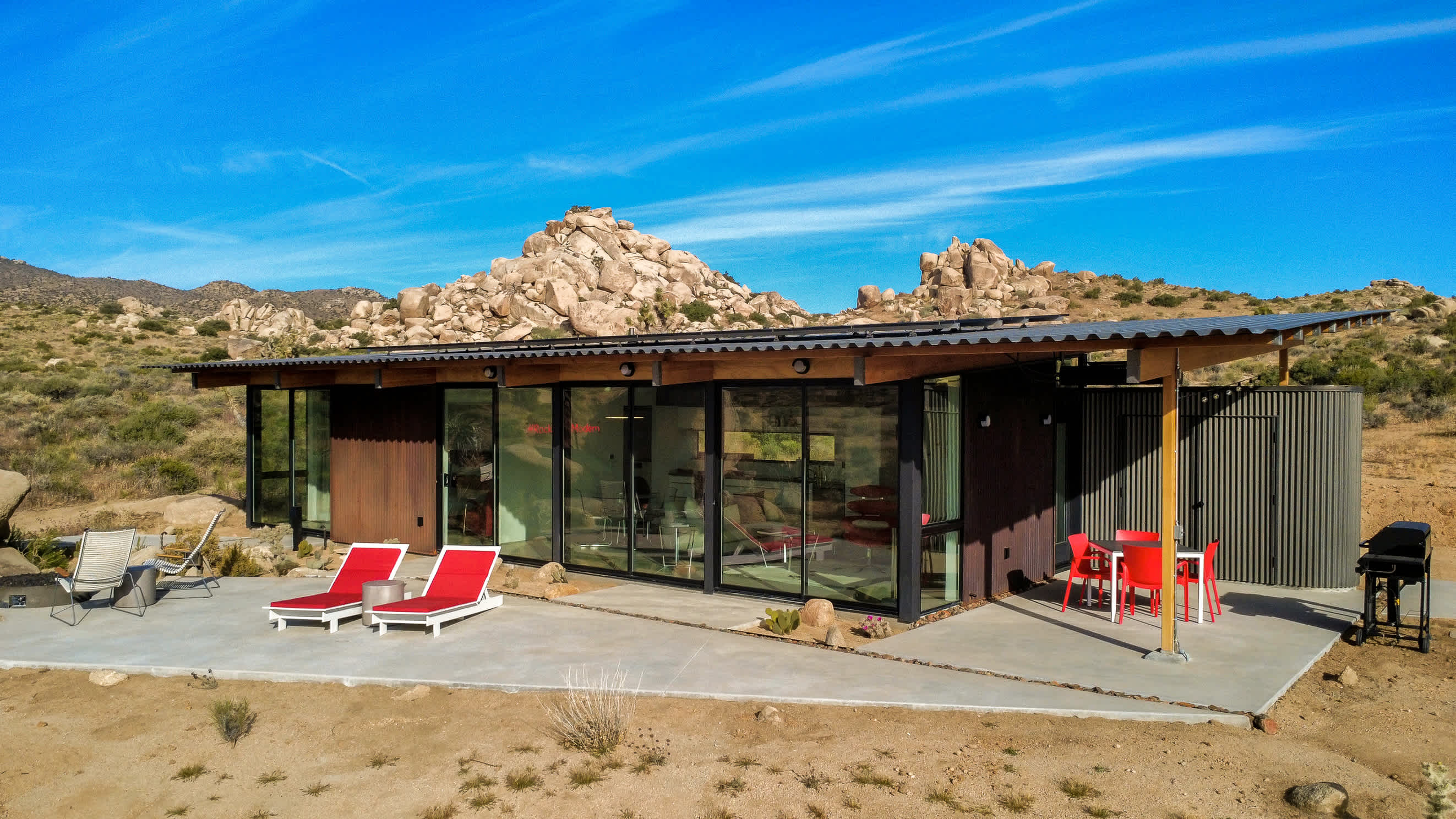 Patio featuring heated dining area, loungers and fire pit.