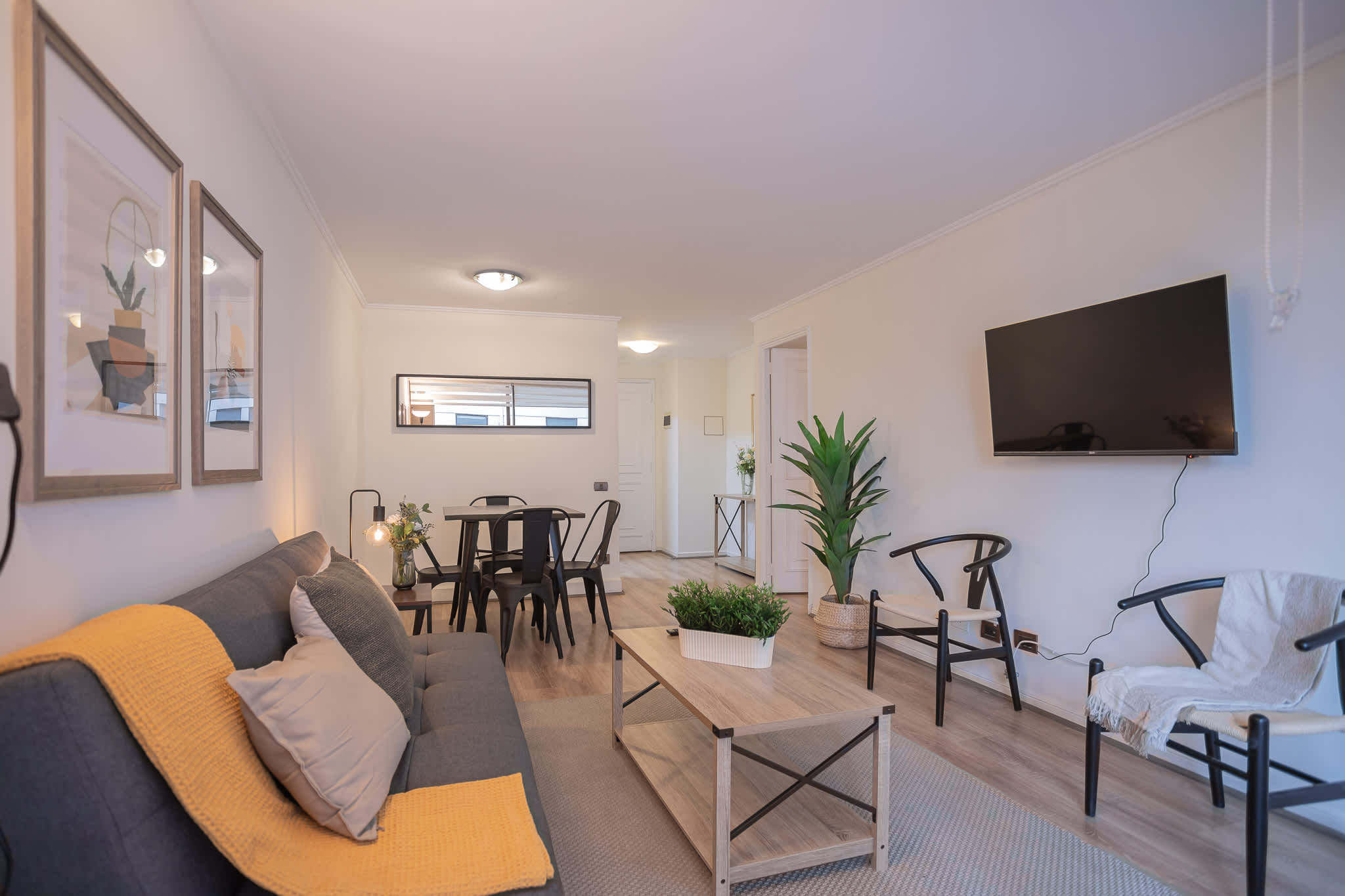 Relax in this cozy living space with modern decor and a wall-mounted TV, perfect for unwinding after a day of exploring.