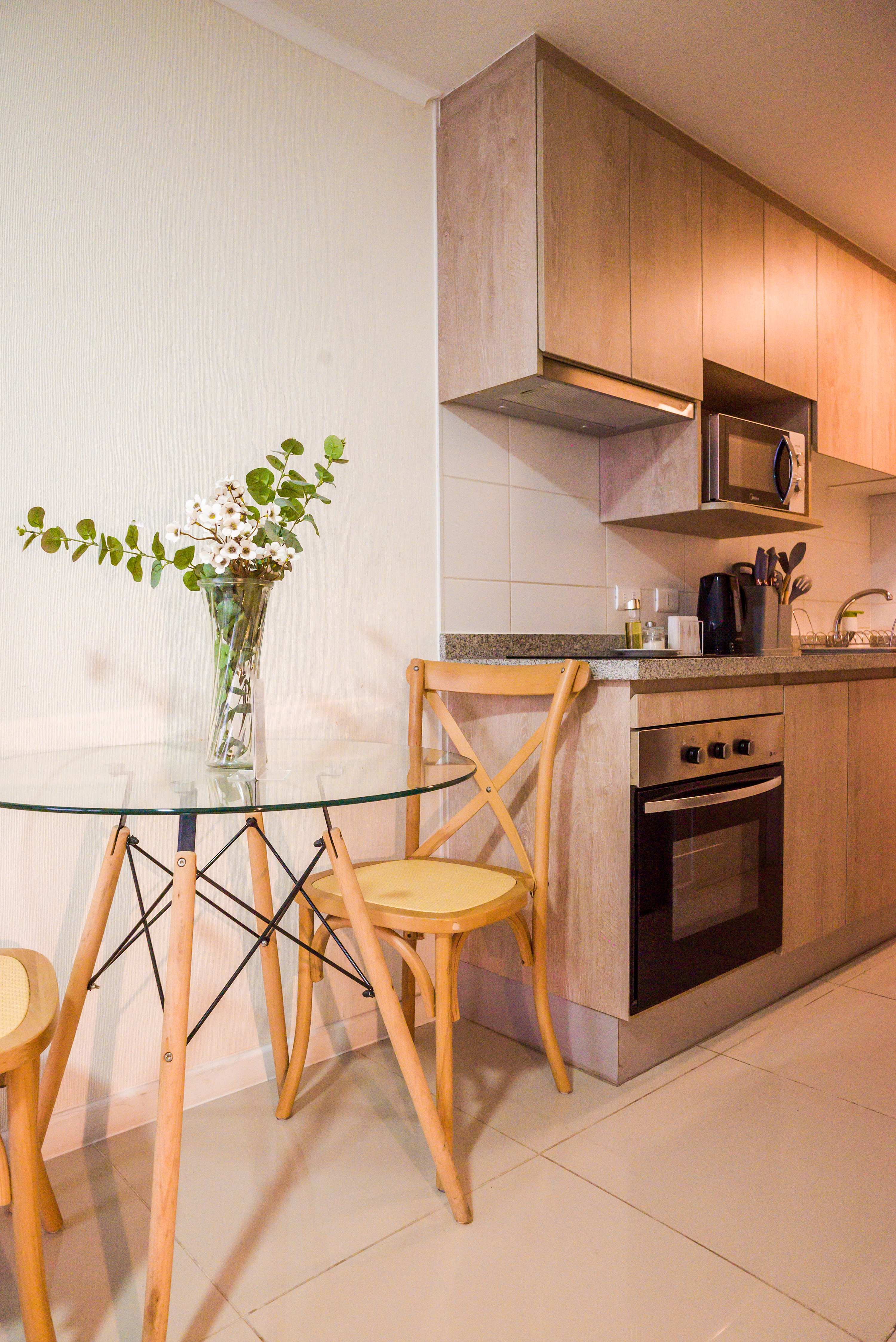 Cozy kitchen with modern amenities and a charming dining area, perfect for intimate meals.