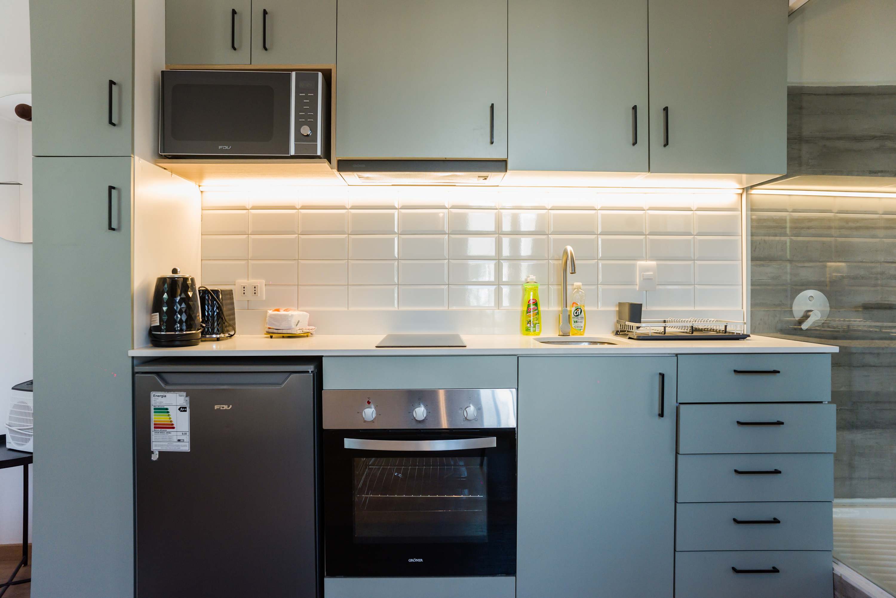 Sleek and modern kitchen with all essentials for a comfortable stay in the heart of the city.