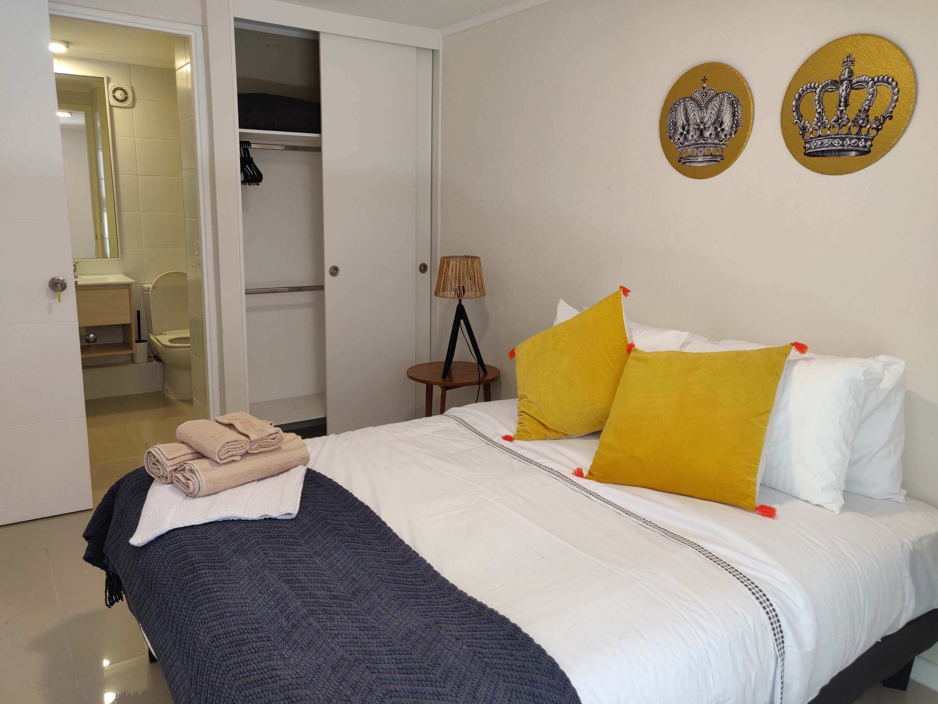 Relax in this cozy bedroom with modern decor and convenient ensuite bathroom, perfect for a comfortable stay.