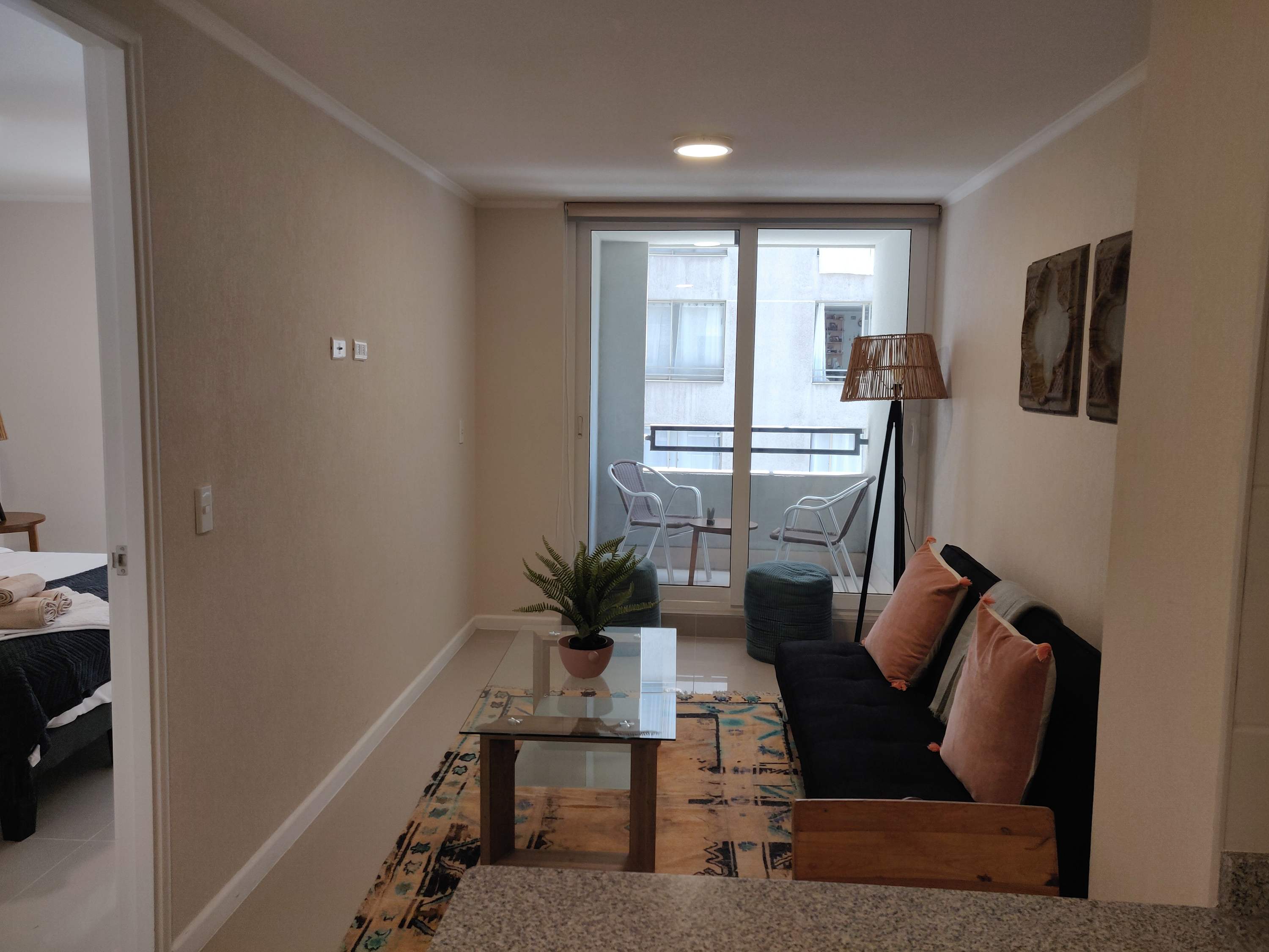 Cozy living space with a private balcony, perfect for enjoying a morning coffee or evening relaxation.