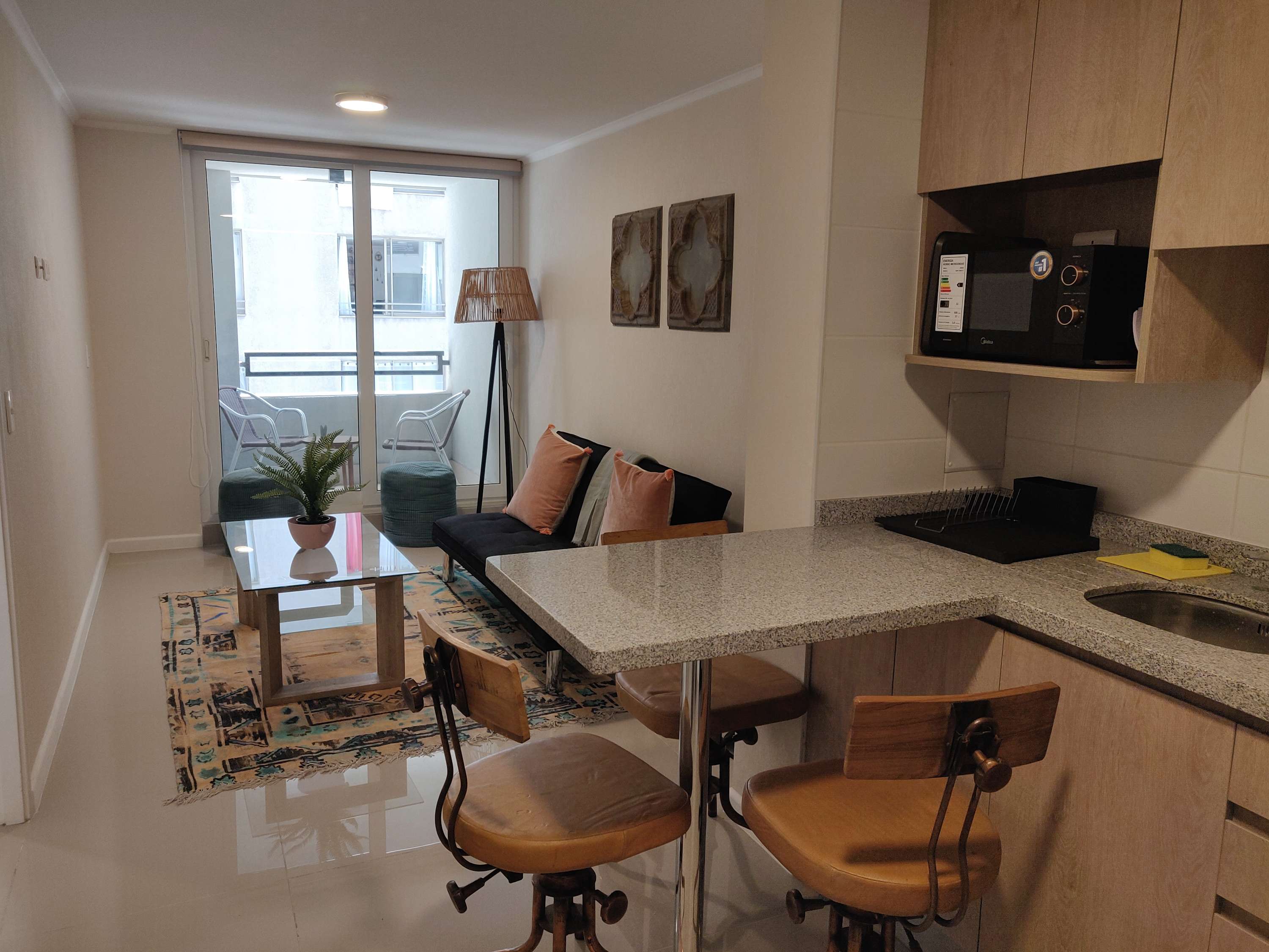 Cozy studio living area with a balcony, perfect for relaxing after exploring the city.