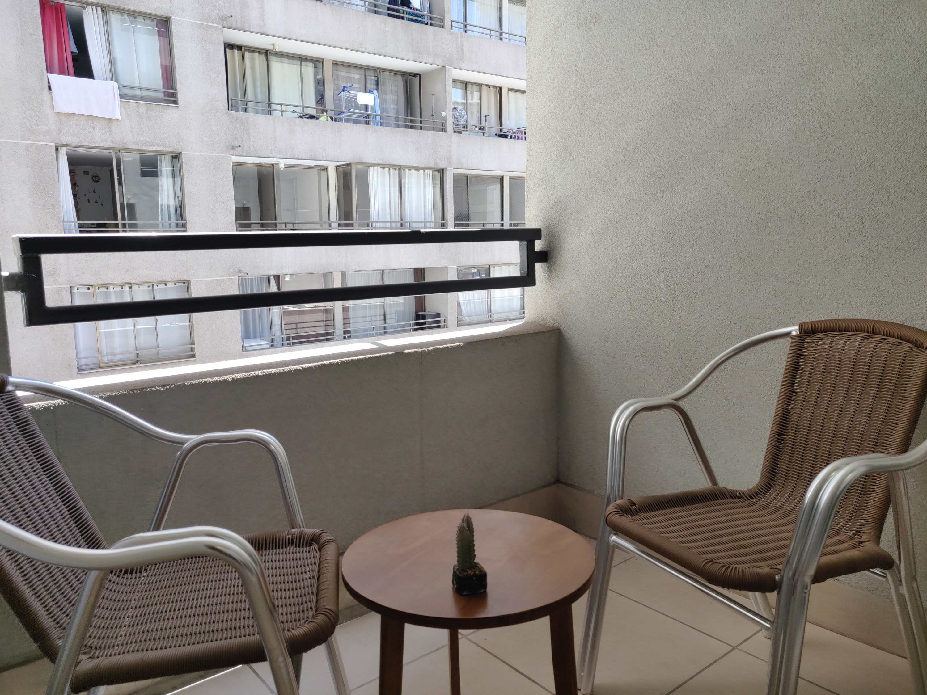 Cozy private balcony perfect for morning coffee or evening relaxation, with a view of the cityscape.