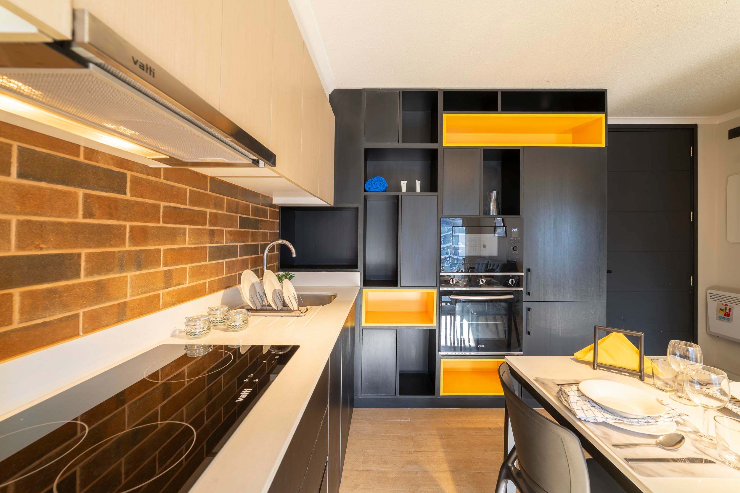 Stylish and modern kitchen with vibrant accents, perfect for a cozy meal for two.