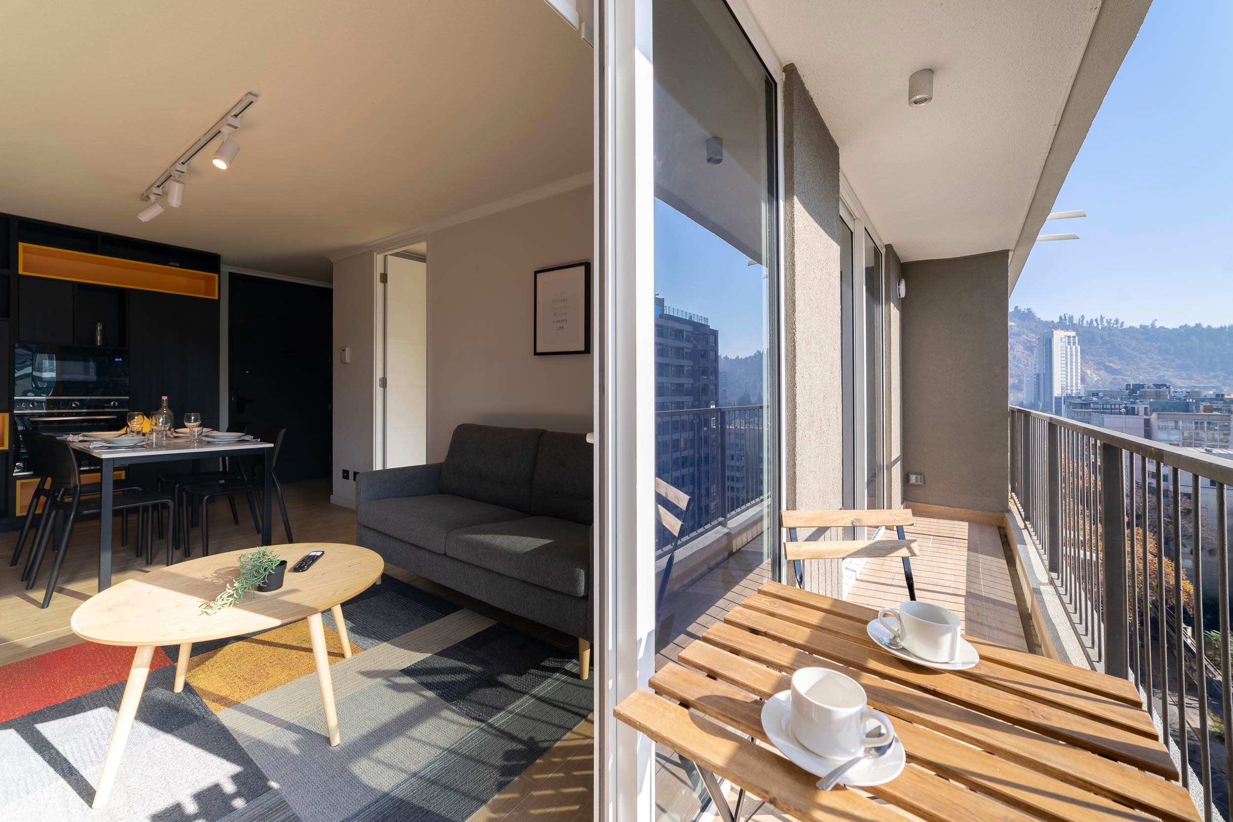 Bright and modern living space with a cozy balcony offering stunning city views. Perfect for a relaxing stay in the heart of Chile.