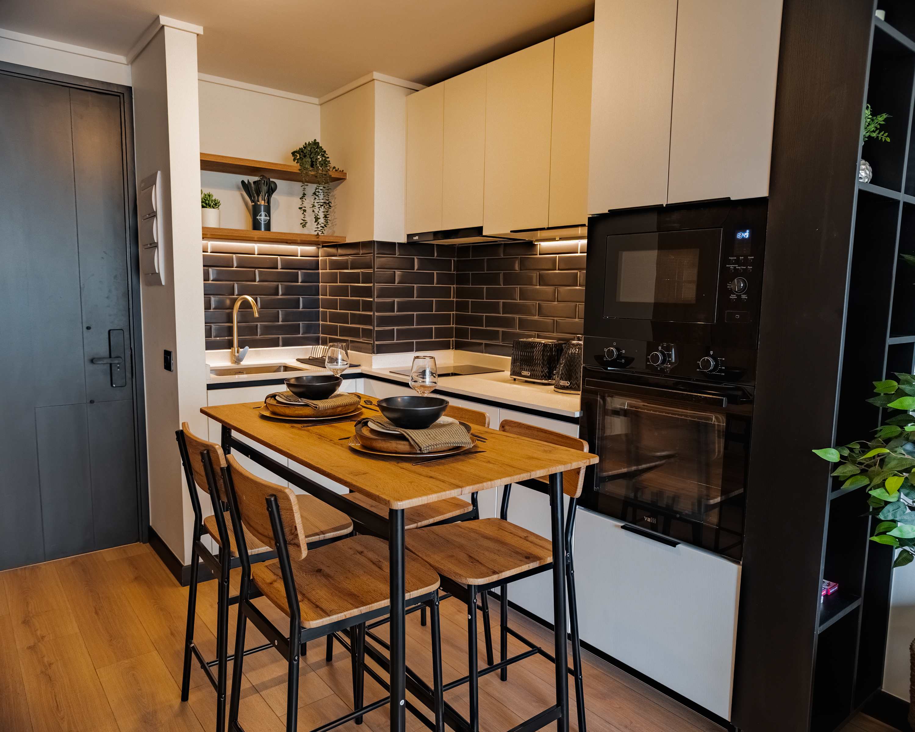 Chic and modern kitchen with stylish dining area, perfect for intimate meals and gatherings.