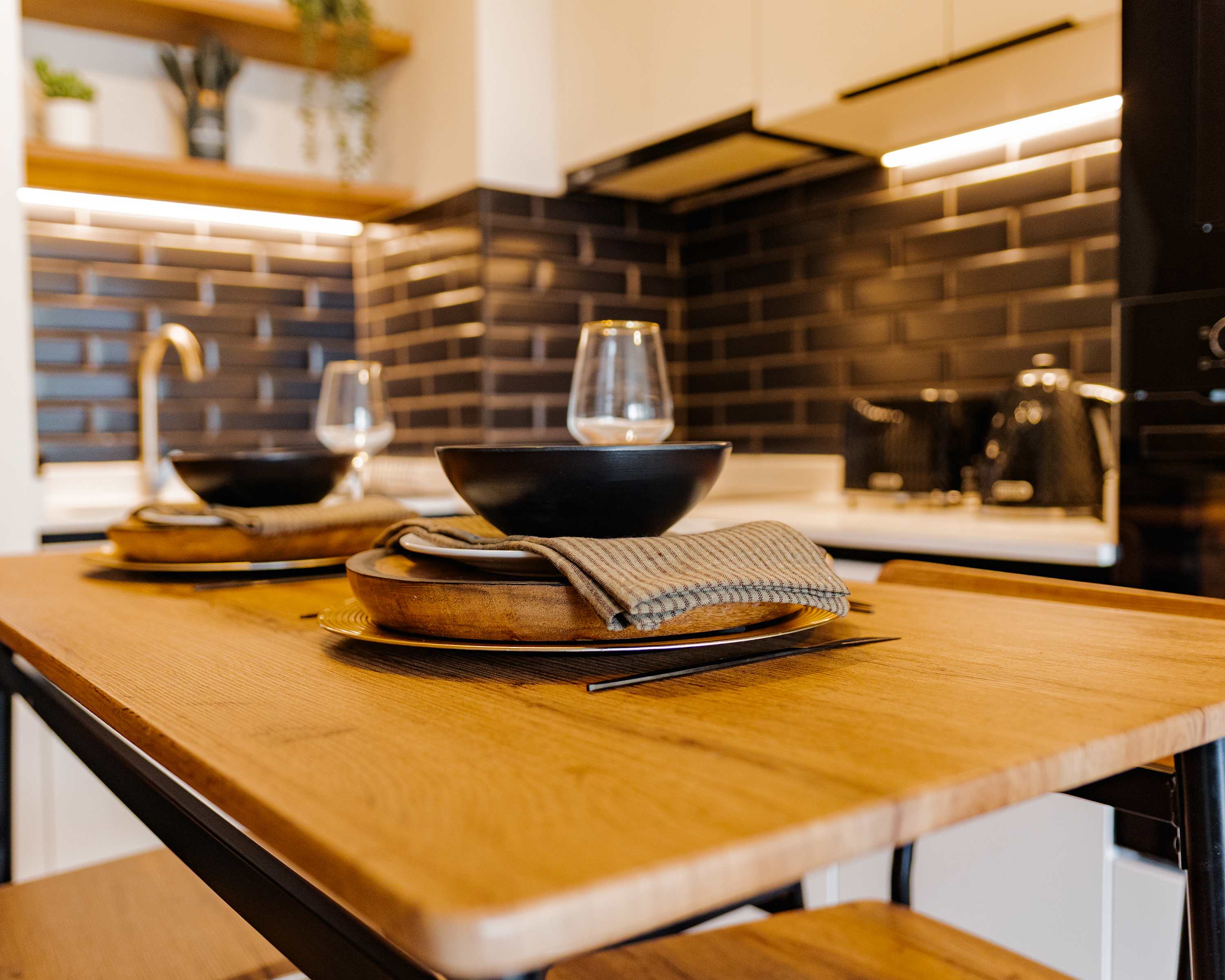Cozy and modern kitchen with stylish dining setup, perfect for intimate meals.