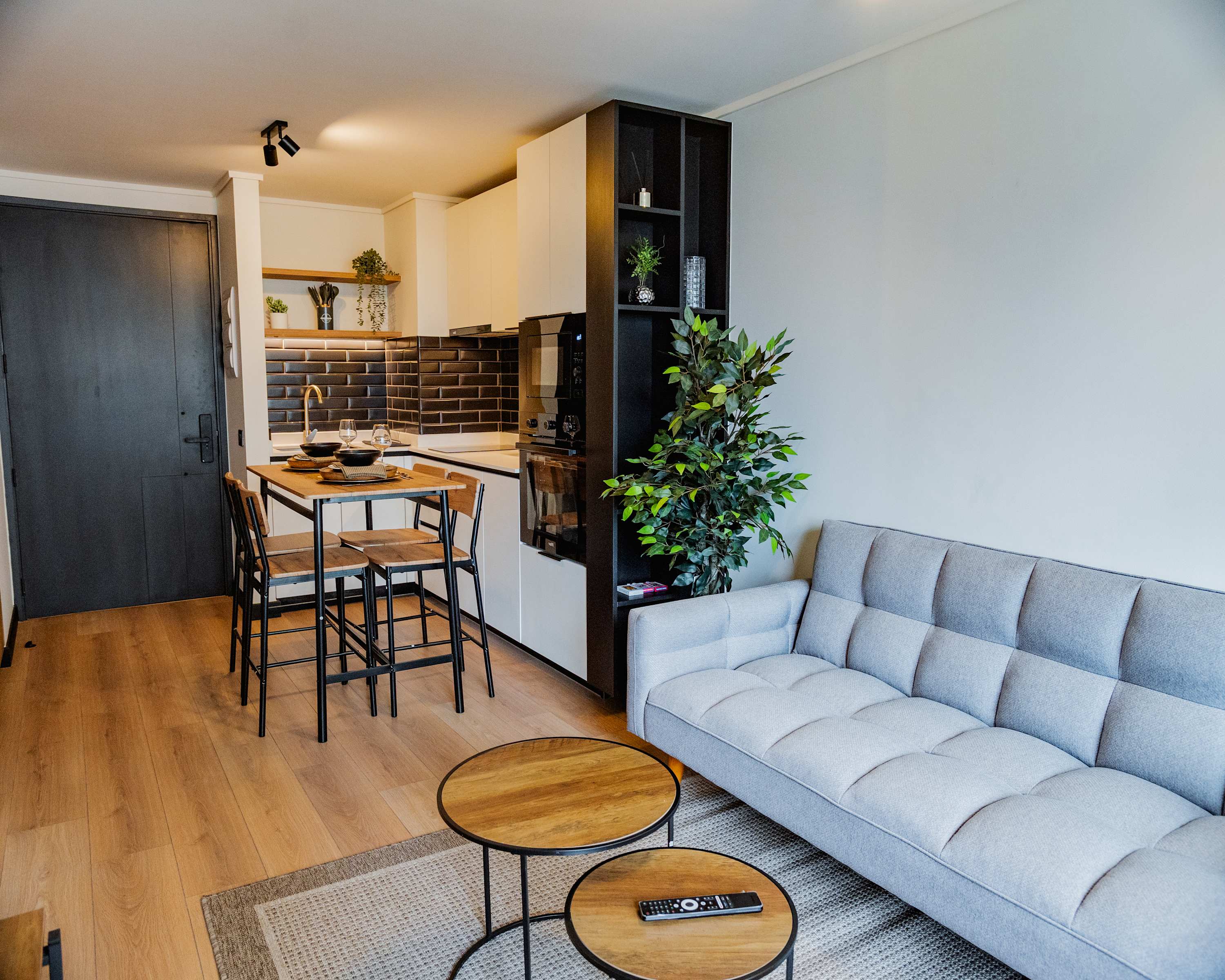Cozy studio apartment with modern kitchen and stylish living area, perfect for a comfortable stay.