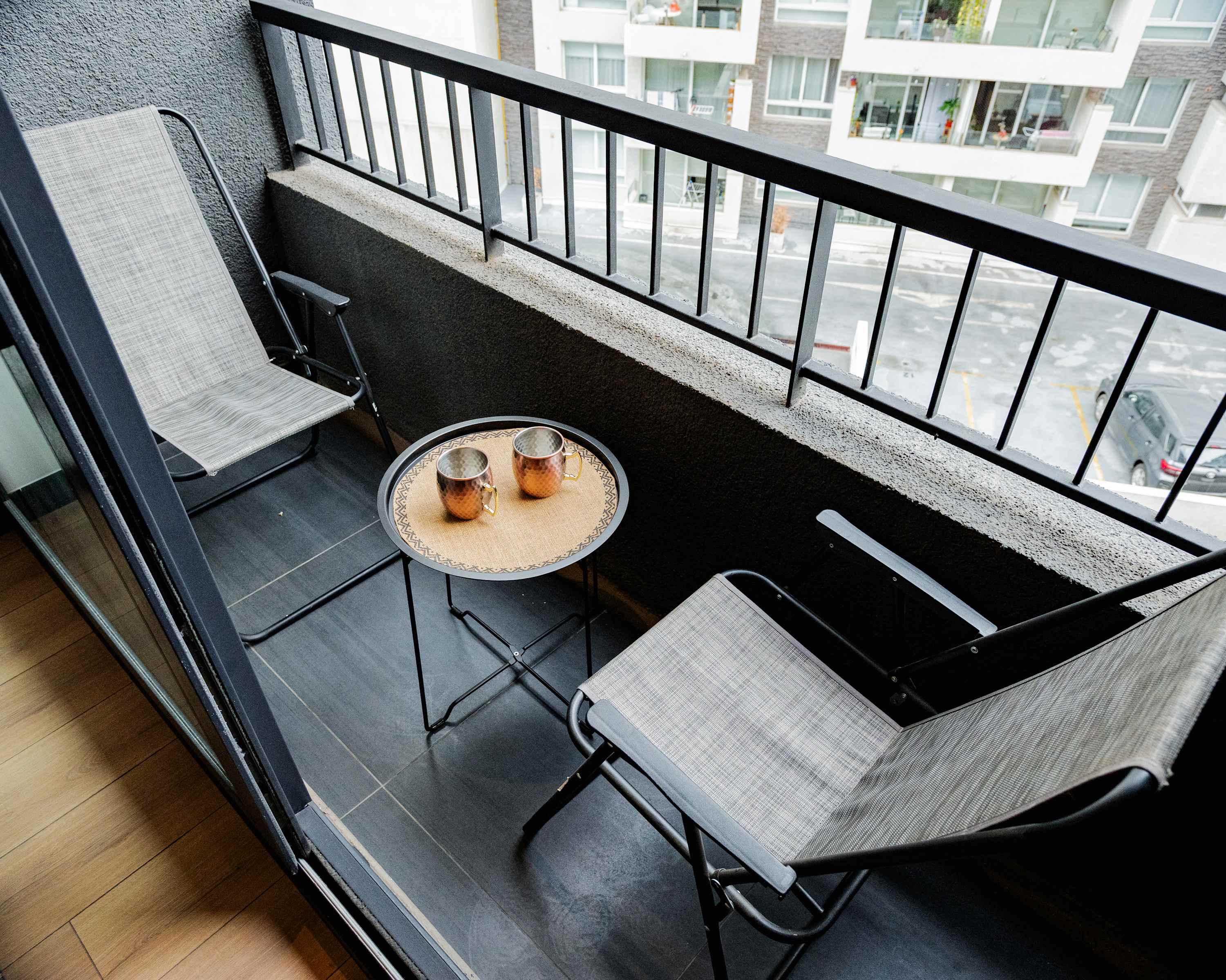 Cozy private balcony with seating and a view, perfect for morning coffee or evening relaxation.