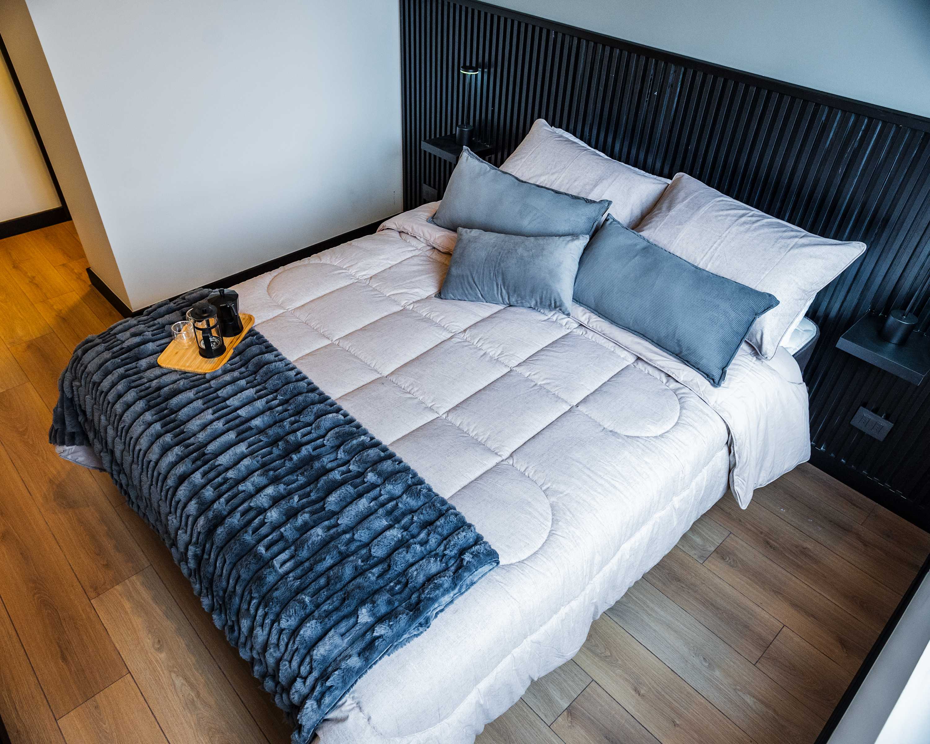Relax in this stylish bedroom with plush bedding and a cozy ambiance, perfect for unwinding after a day exploring the city.
