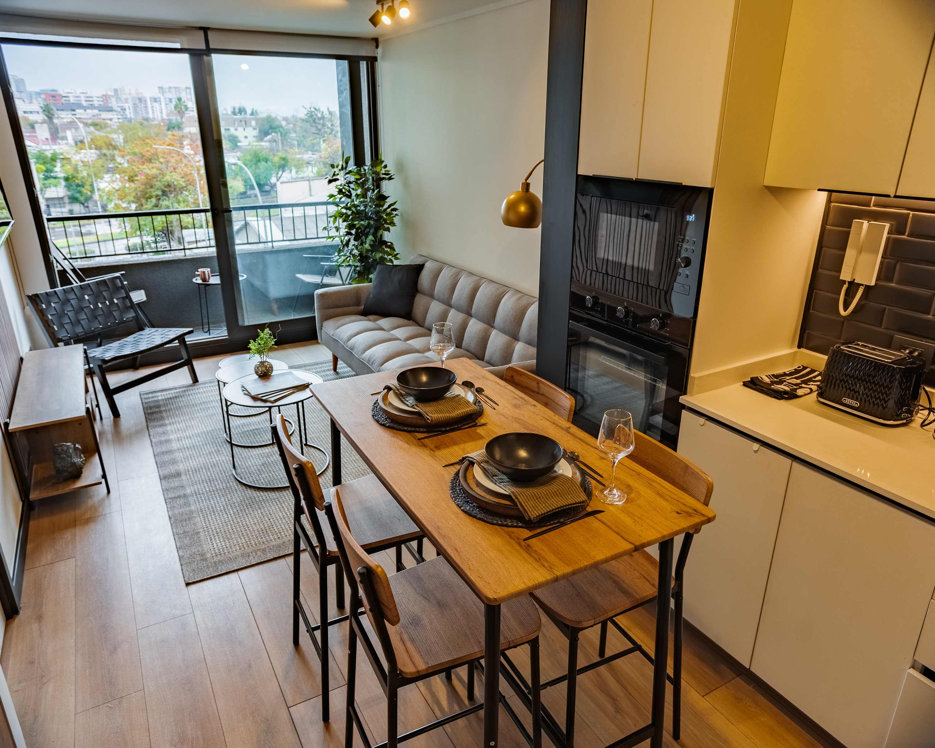 Cozy and modern living space with a stunning view from the balcony, perfect for a relaxing stay in the heart of the city.