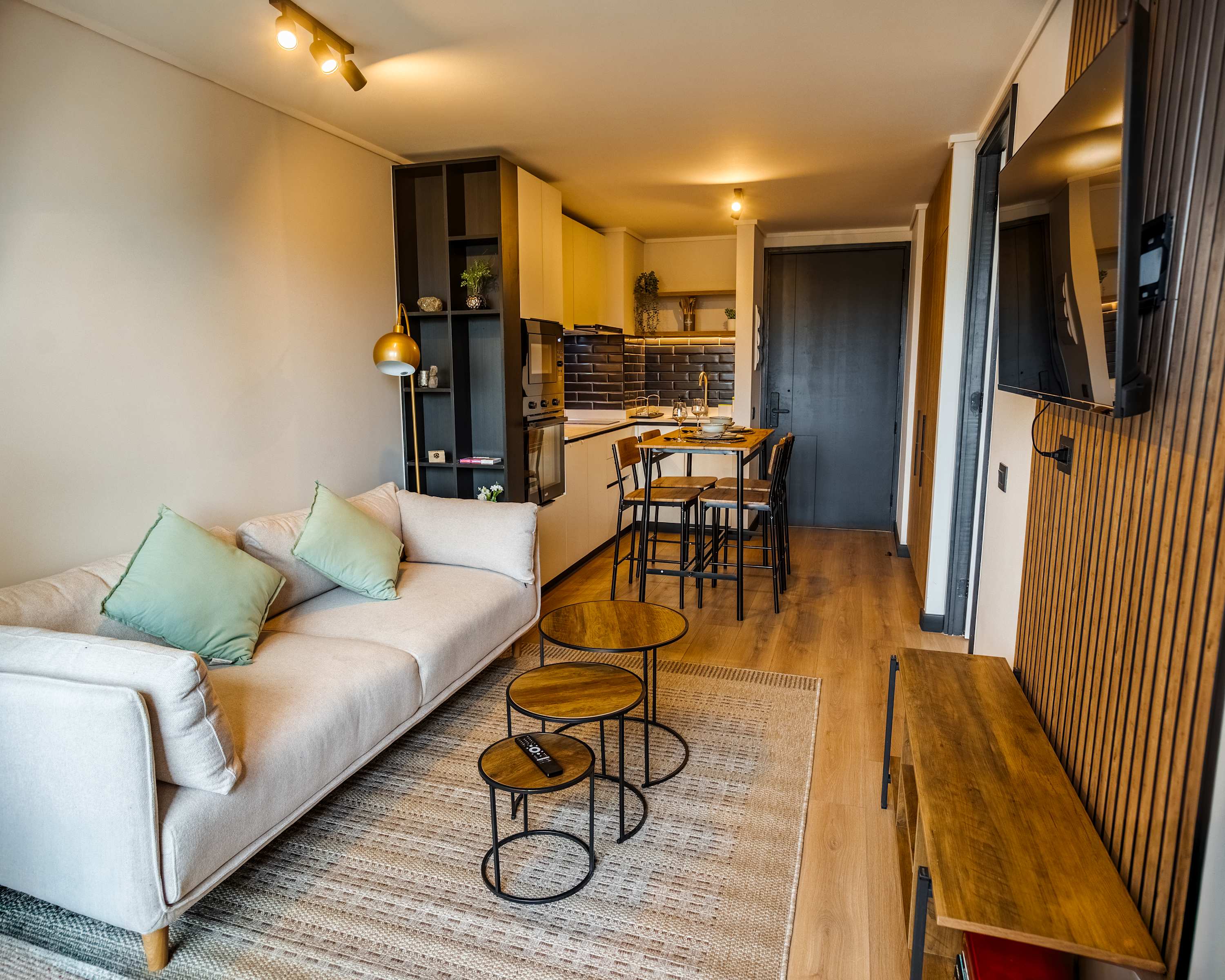 Chic and cozy living space with modern kitchen and dining area, perfect for a relaxing stay in the heart of the city.
