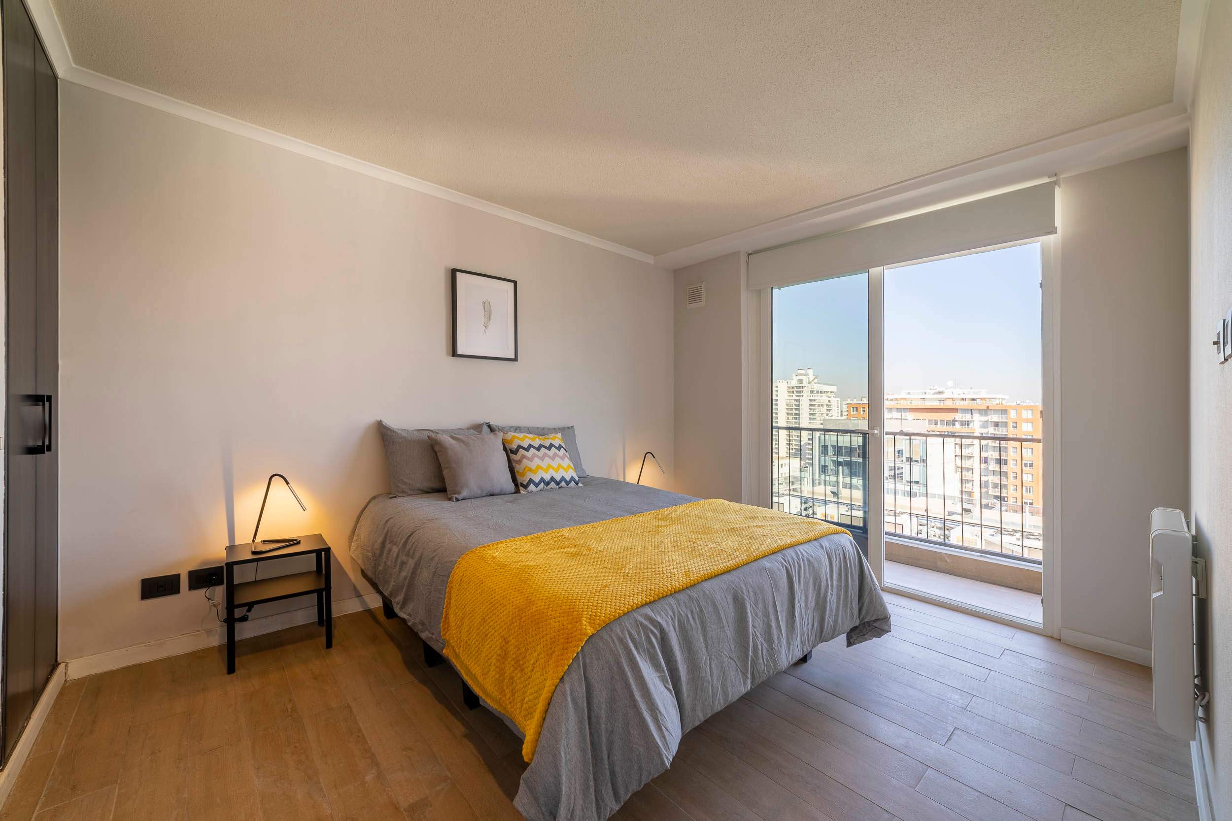 Bright and cozy bedroom with city views, perfect for a relaxing stay in the heart of the city.