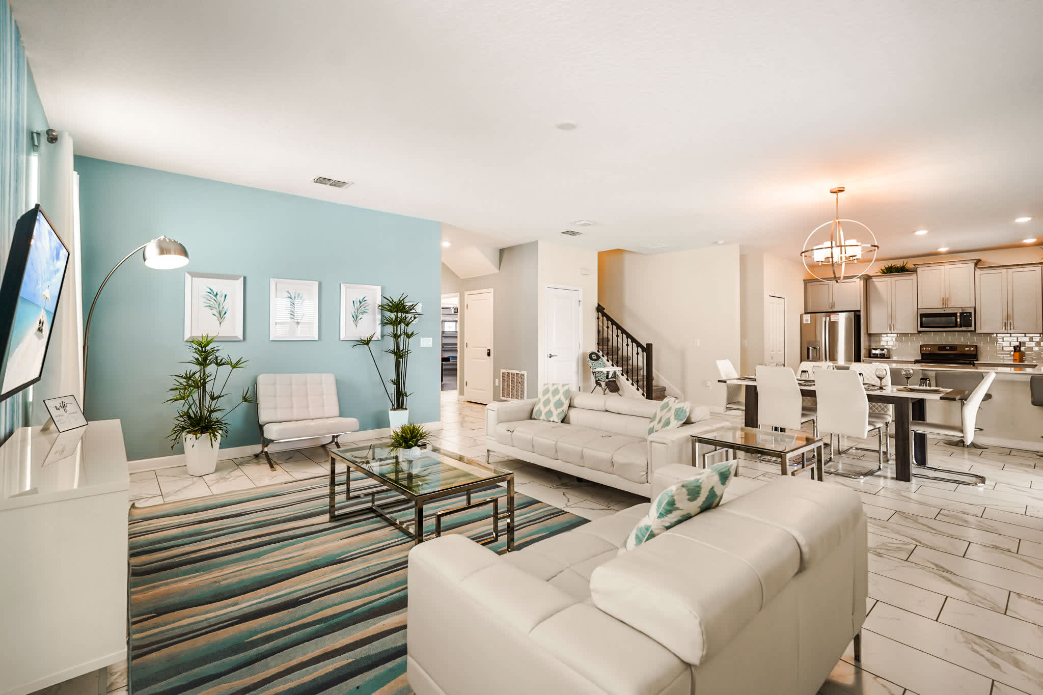 Experience luxury in this modern open-plan living area with stylish decor and ample seating, perfect for family gatherings.