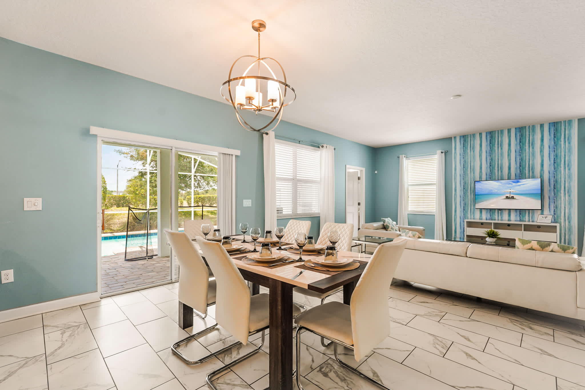 Enjoy meals with a view in this elegant dining area, featuring a poolside backdrop and modern decor.